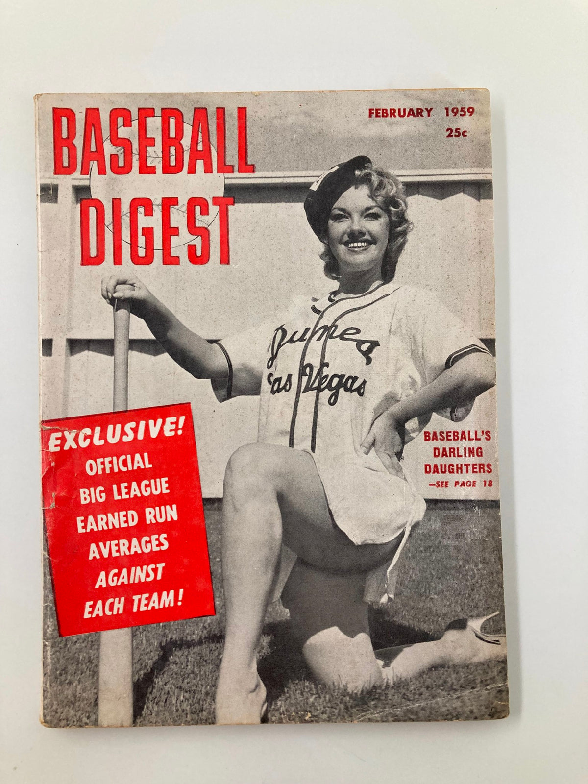 VTG Baseball Digest February 1959 cover featuring a smiling woman in a baseball uniform, labeled 'Baseball's Darling Daughters.' The magazine is promoting exclusive content and lists the price as 25 cents.