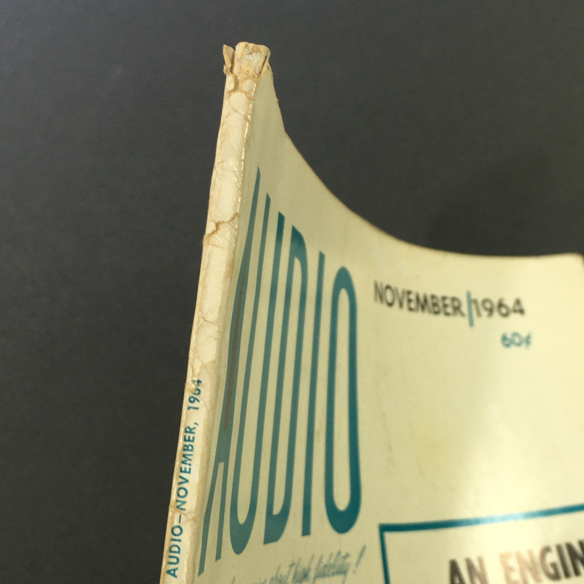 Close-up view of the spine and top edge of the VTG Audio and Music Magazine from November 1964, showcasing vintage wear and the publication date.