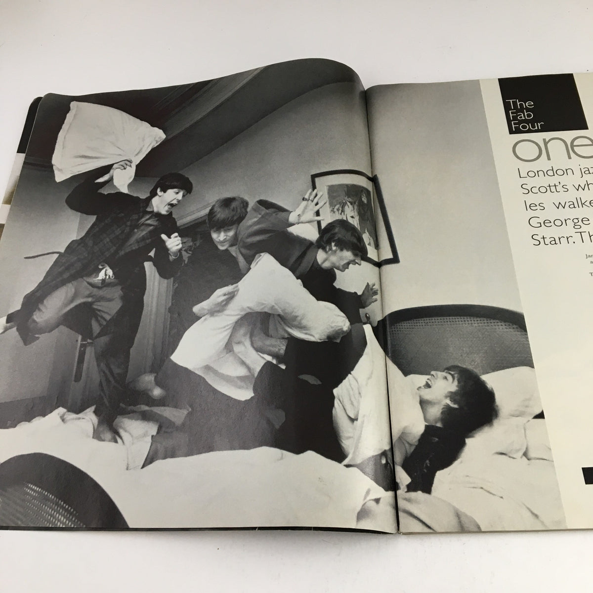 Another inside spread of Life Magazine December 1995 featuring The Beatles in a playful pillow fight scene, capturing the joy and camaraderie of the band, titled 'Life Magazine December 1995: The Beatles From Yesterday to Today'.