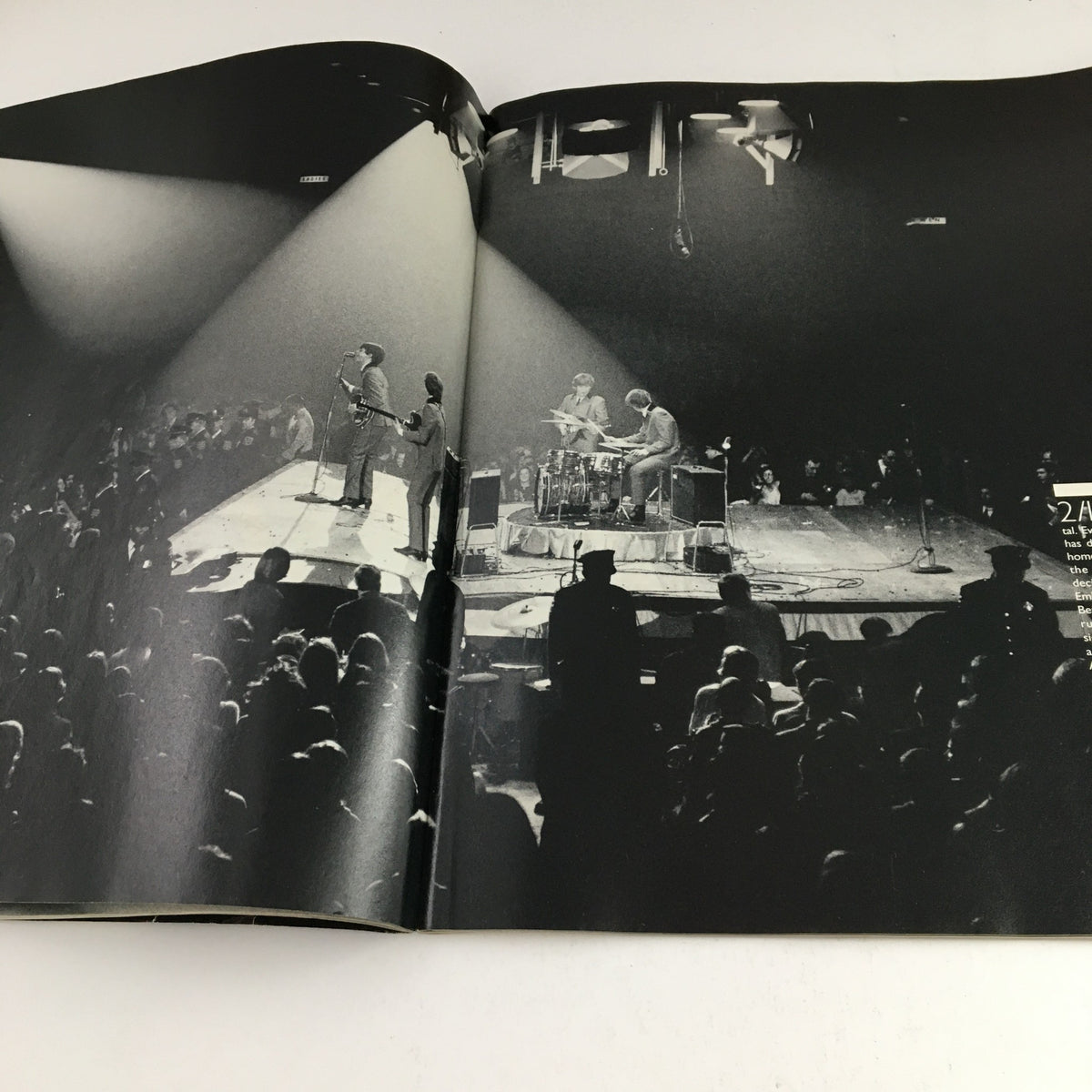 The Beatles performing live on stage, captured in a dramatic black and white photograph from Life Magazine December 1995: The Beatles From Yesterday to Today.