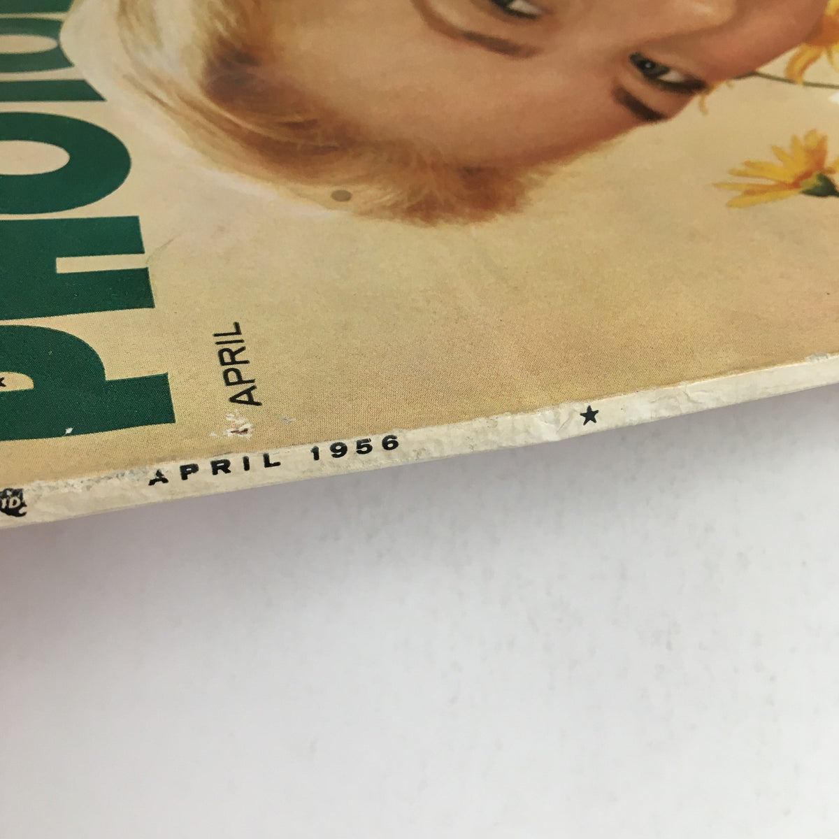 Close-up view of the cover of Photoplay Magazine April 1956 featuring Grace Kelly and Audrey Hepburn, showcasing the magazine title and publication date.