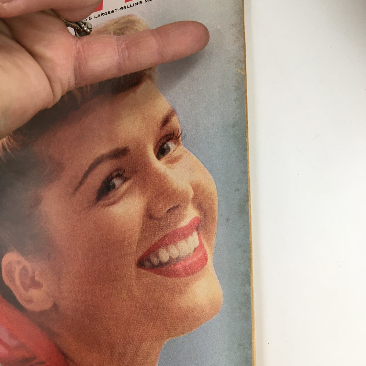Close-up of a smiling woman featured on the cover of Photoplay Magazine May 1955, highlighting the vintage charm associated with classic cinema.