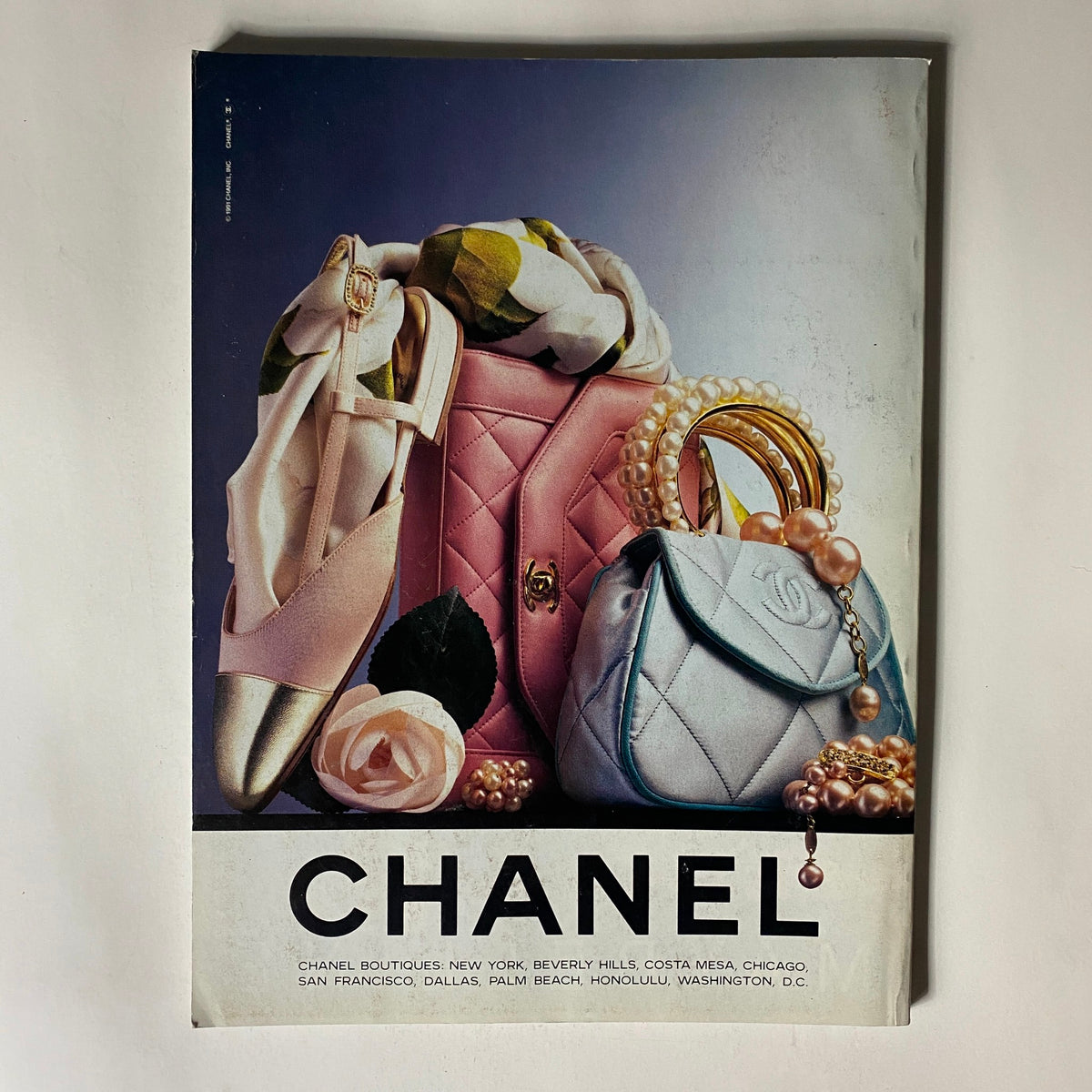 Vogue Magazine June 1991 advertisement showcasing Chanel accessories including handbags and shoes, highlighting luxury fashion trends of the early 1990s.