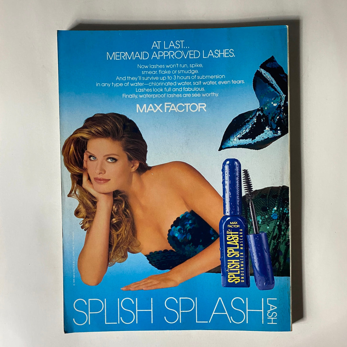 Vogue Magazine May 1991 advertisement for Max Factor's waterproof lashes with a model showcasing mermaid-inspired beauty.