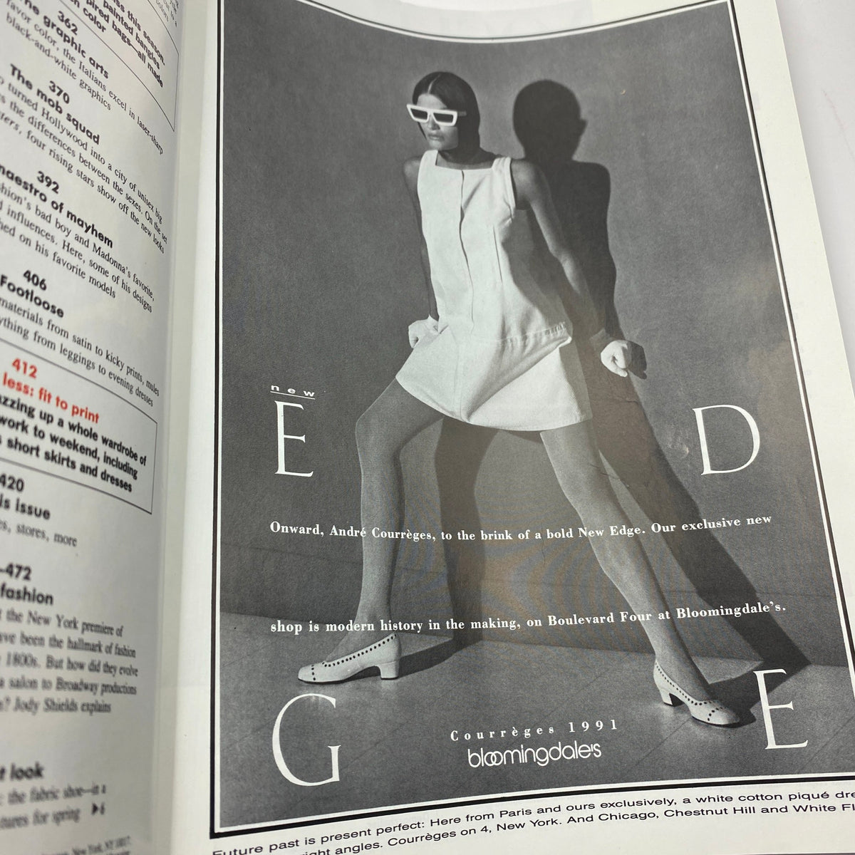 Vogue Magazine March 1991 with a black and white advertisement featuring a model showcasing André Courrèges designs in a minimalist look.