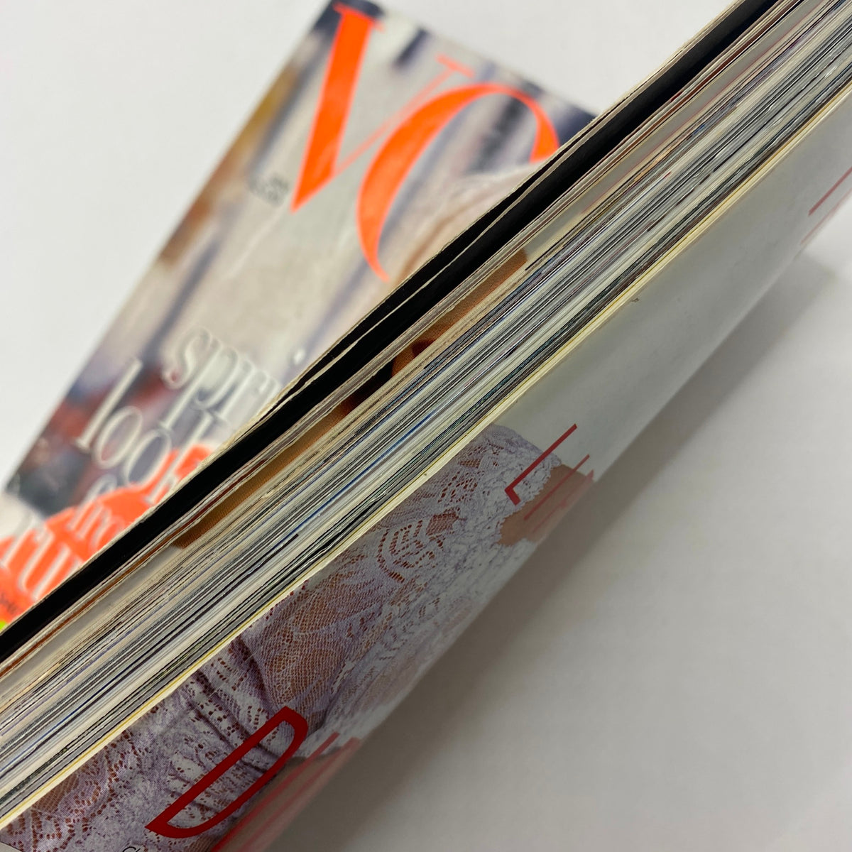 Close-up view of the spine and edges of Vogue Magazine January 1996, illustrating the well-preserved condition of the vintage publication.