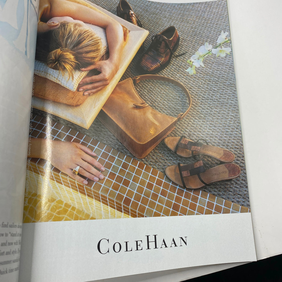 Cole Haan advertisement showcasing a stylish arrangement of fashion accessories, including sandals and a handbag, featured in Vogue Magazine July 2001 Catherine Zeta-Jones by Herb Ritts.