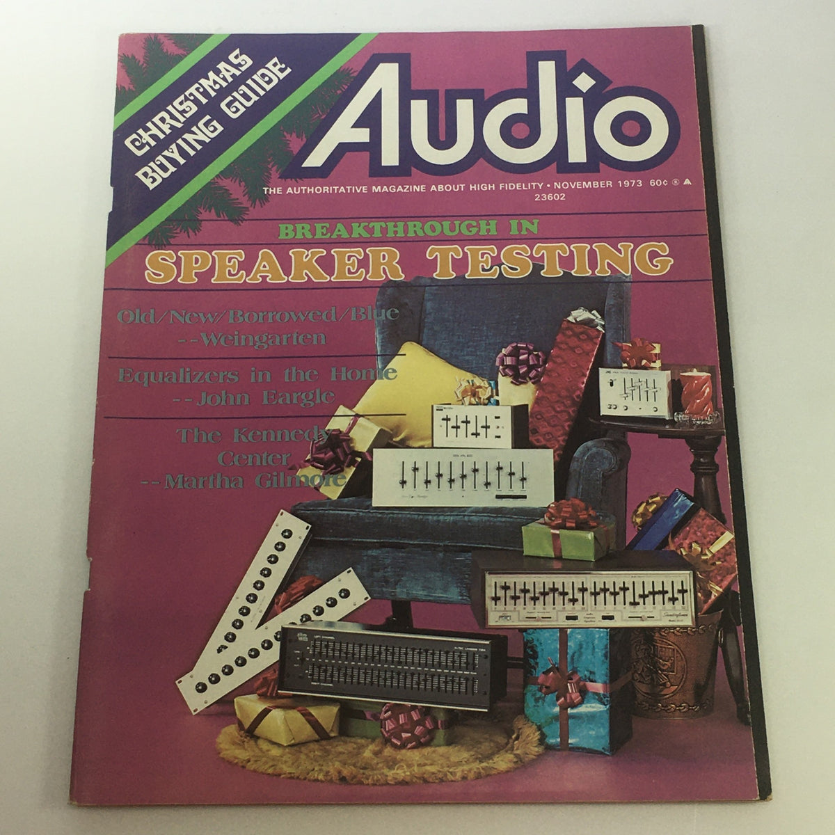 Cover of VTG Audio & Music Magazine from November 1973 featuring 'The Kennedy Center' by Martha Gilmore. The magazine emphasizes 'Breakthrough in Speaker Testing' with a colorful holiday theme, showcasing audio equipment surrounded by wrapped gifts.