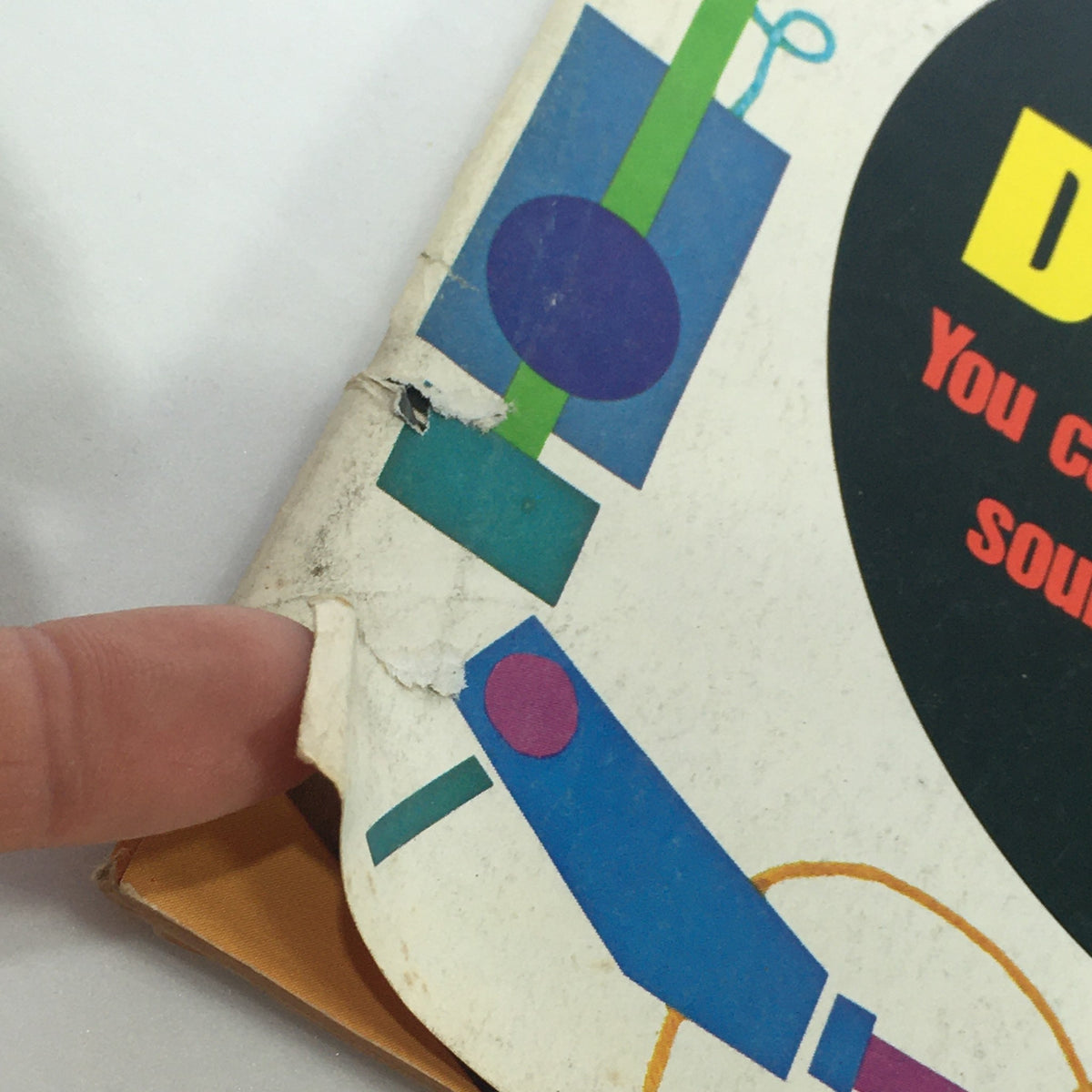 Close-up view of the corner of the VTG High Fidelity Music Magazine July 1975, showcasing wear and tear, with vibrant retro graphics, hinting at its collectible nature and history in disco music.