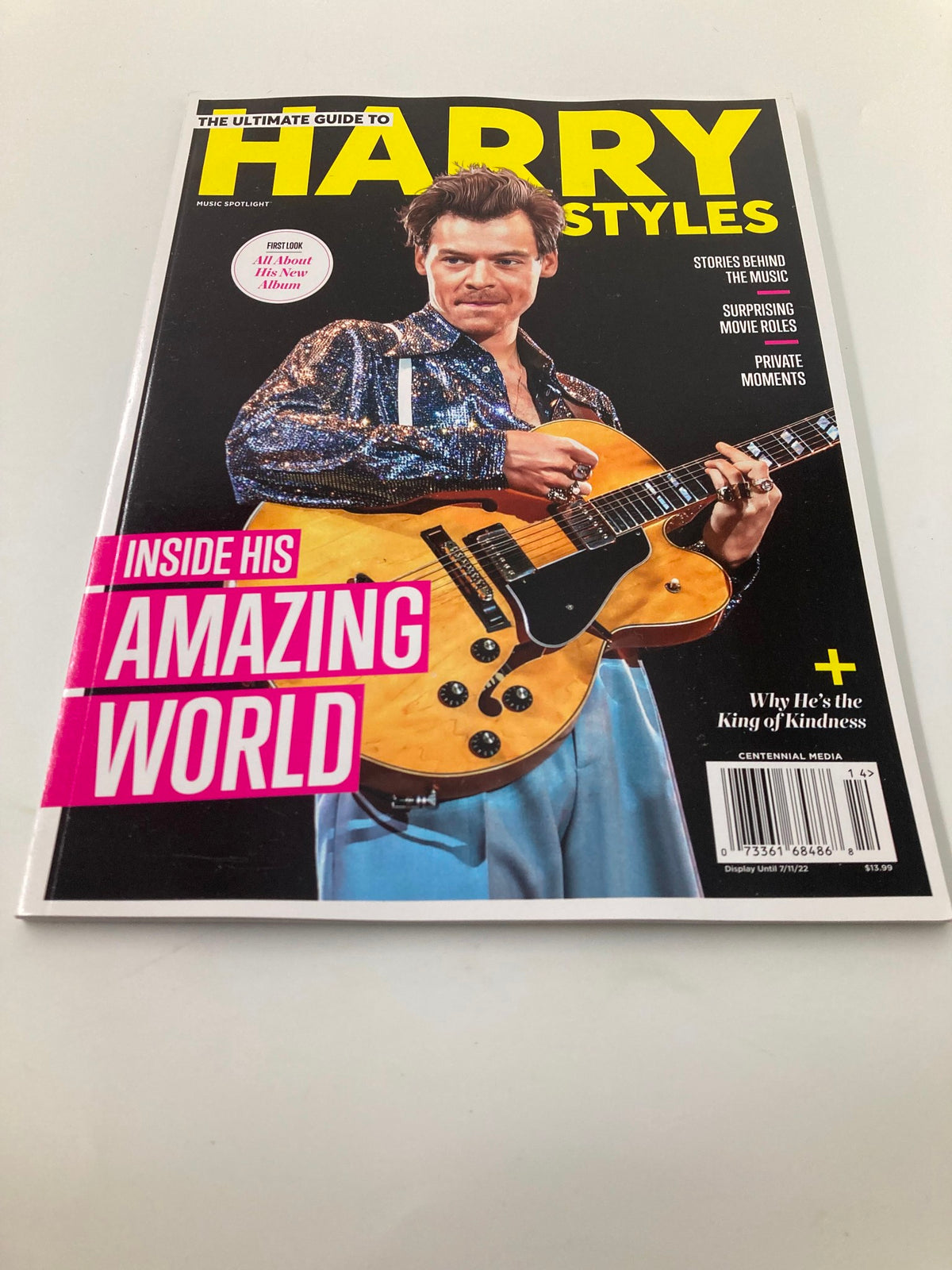 Front cover of Music Spotlight Magazine July 2022, displaying the Ultimate Guide to Harry Styles, with Harry Styles in a sequined jacket holding a guitar, and the main caption 'Inside His Amazing World' alongside insights about his private moments.