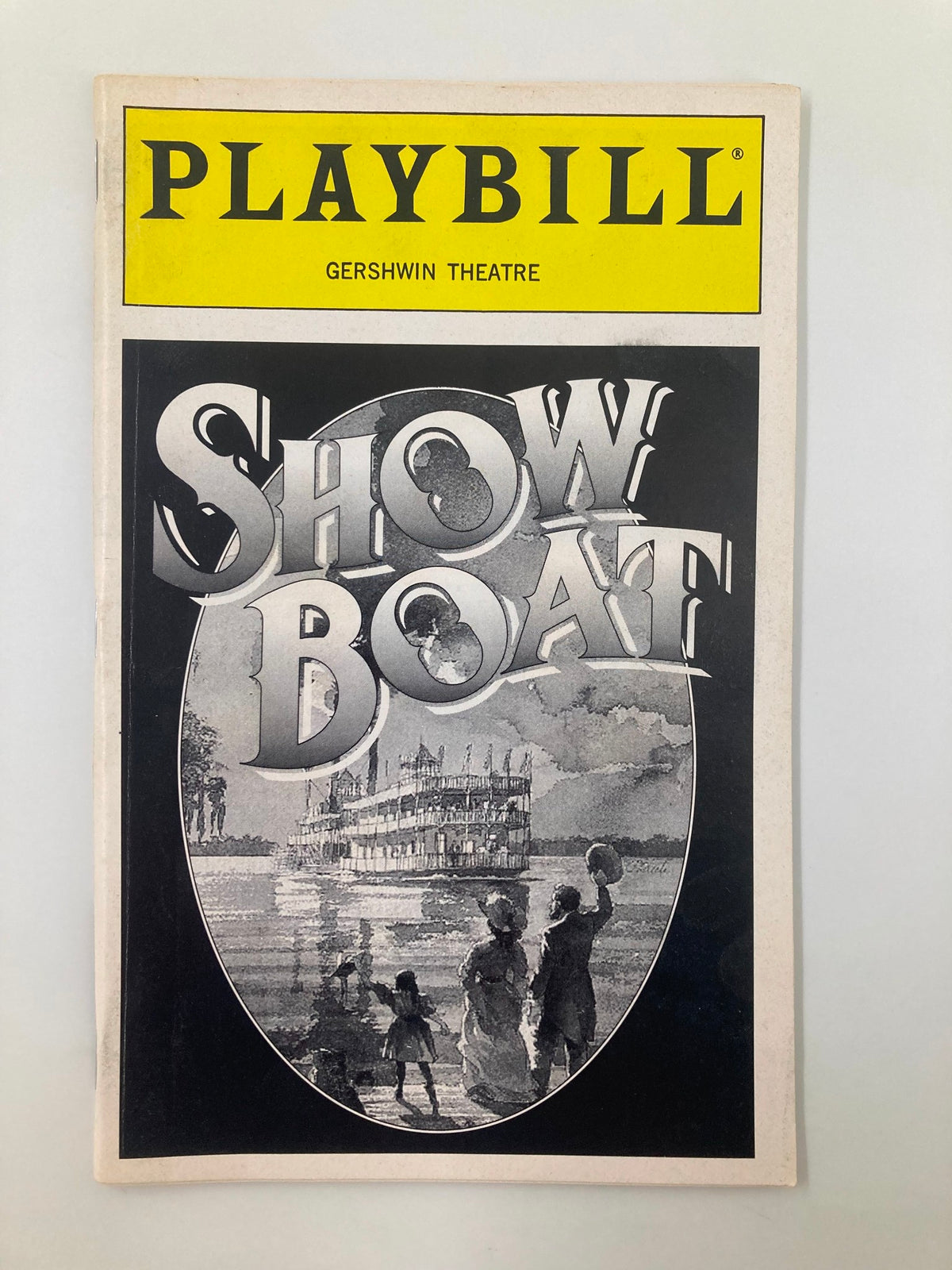1995 Playbill for Show Boat at Gershwin Theatre featuring iconic cover art depicting a river scene with a steamboat and figures on the shore.