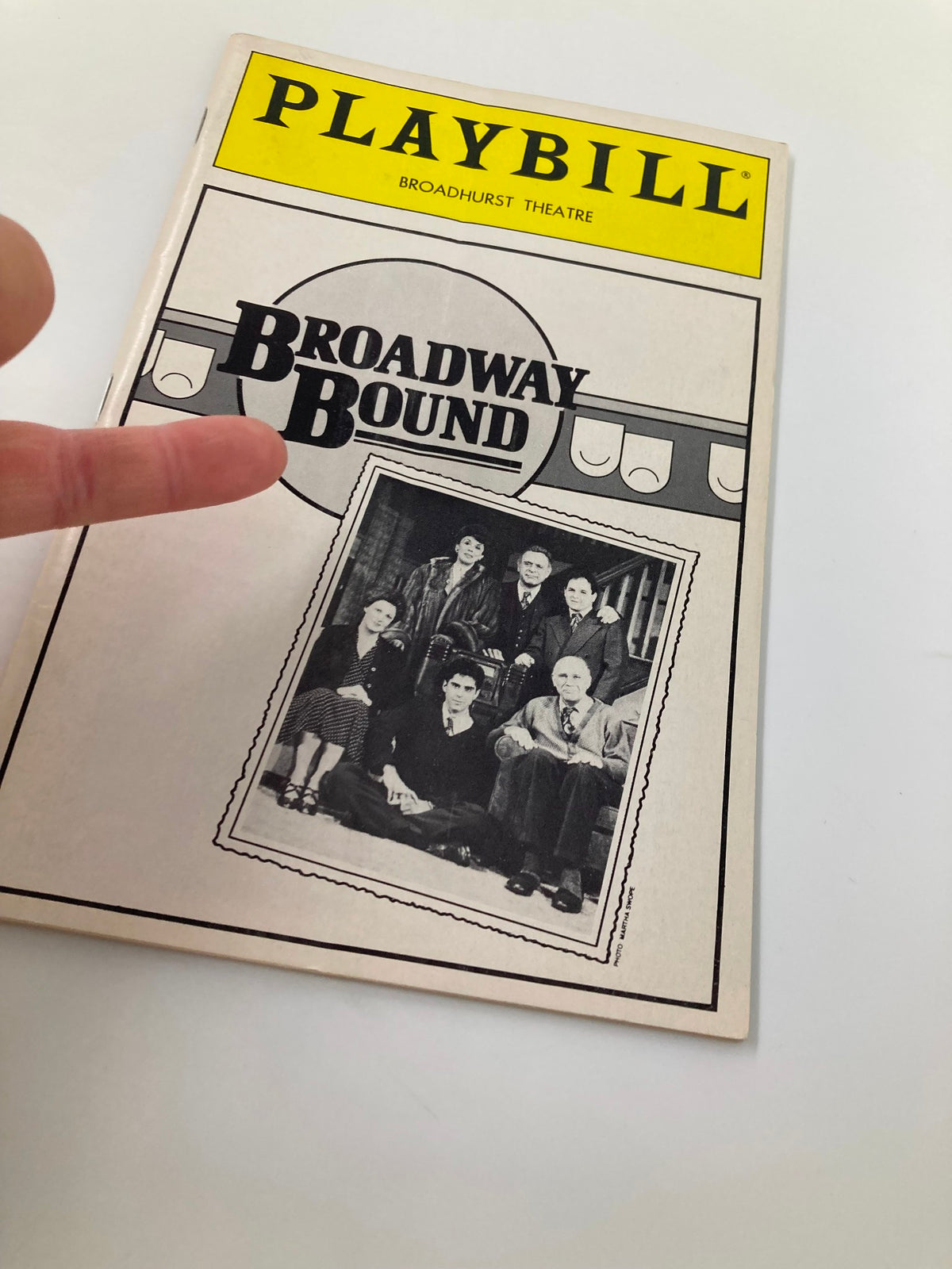1986 Playbill for Broadway Bound at Broadhurst Theatre with a hand pointing at the cast photo on the cover.