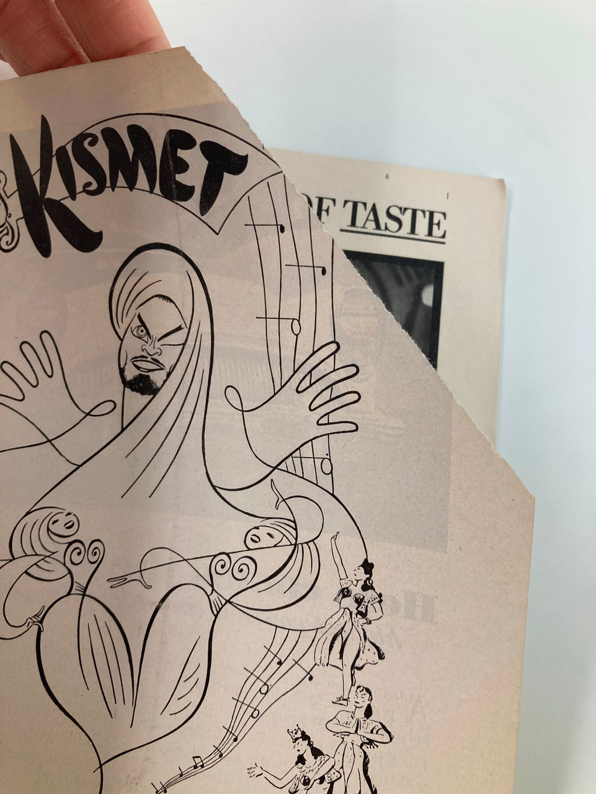 1954 Playbill The Ziegfeld Theatre Kismet featuring artwork of a stylized character and musical notes, showcasing the vintage aesthetic of Broadway productions.