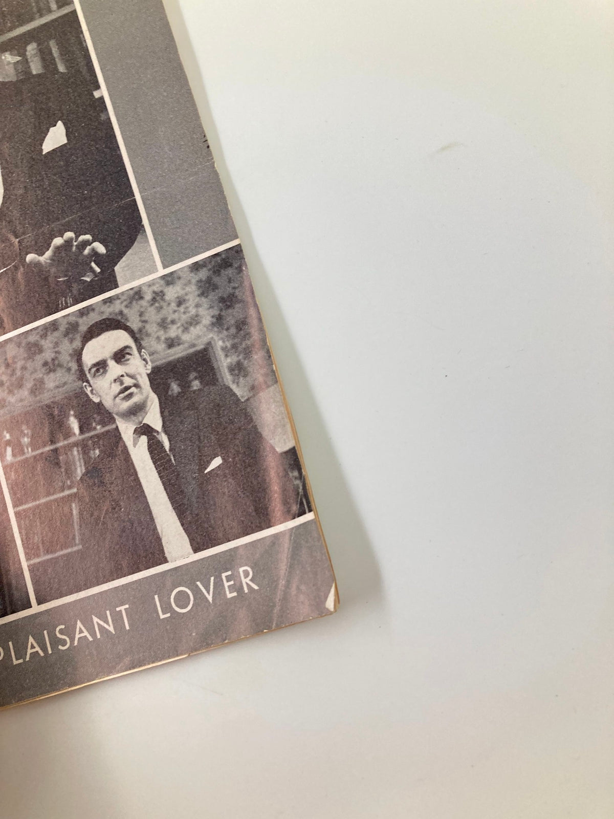 Close-up view of the 1961 Playbill for 'The Complaisant Lover,' highlighting the detailed images and title on the front.