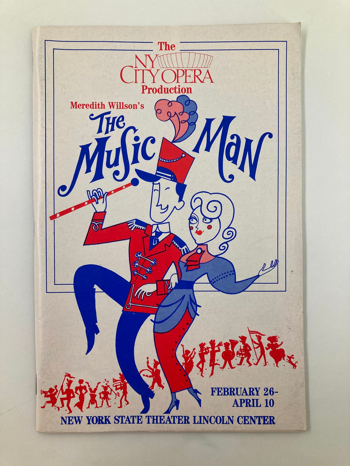 1988 New York City Opera production playbill for The Music Man featuring whimsical illustrations of characters; highlight of the show dates: February 26 to April 10 at New York State Theater, Lincoln Center.