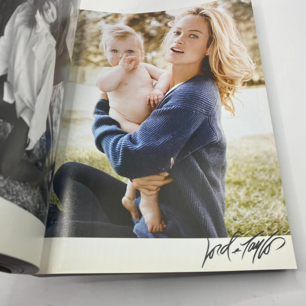 Vogue Magazine September 2007 showcasing a mother holding her baby, reflecting intimate family moments with signature by Lord & Taylor.