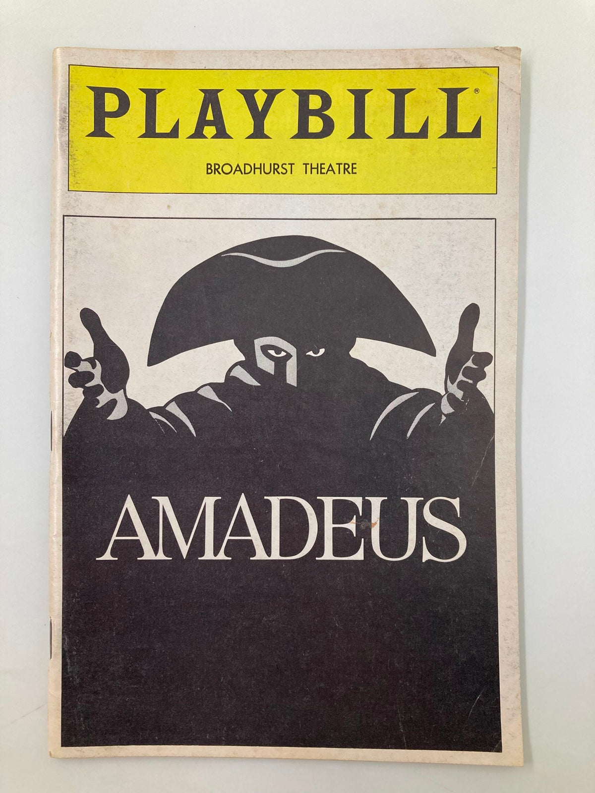 1983 Playbill from the Broadhurst Theater featuring the production of Amadeus, showcasing a dramatic cover design with a silhouette of a character.