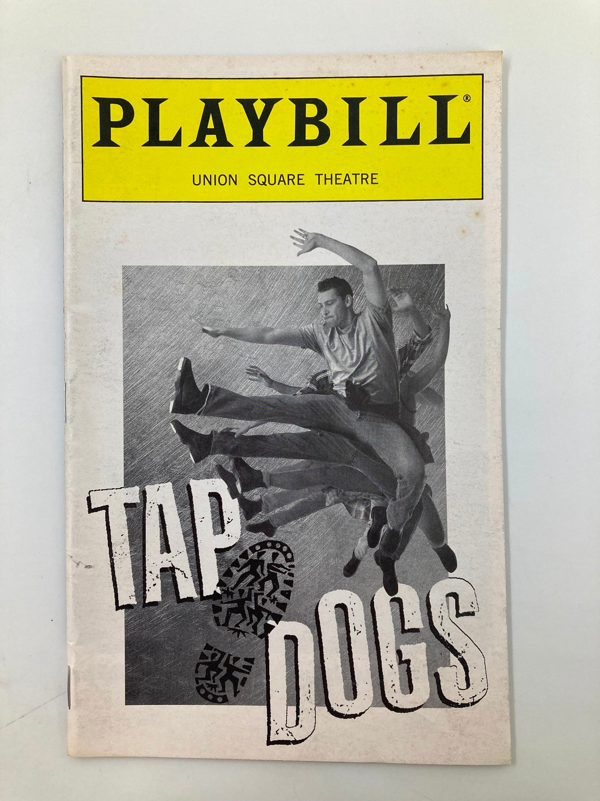 1997 Playbill for Union Square Tap Dogs featuring dynamic tap dance performance with dancers in action, capturing the excitement of live theater.