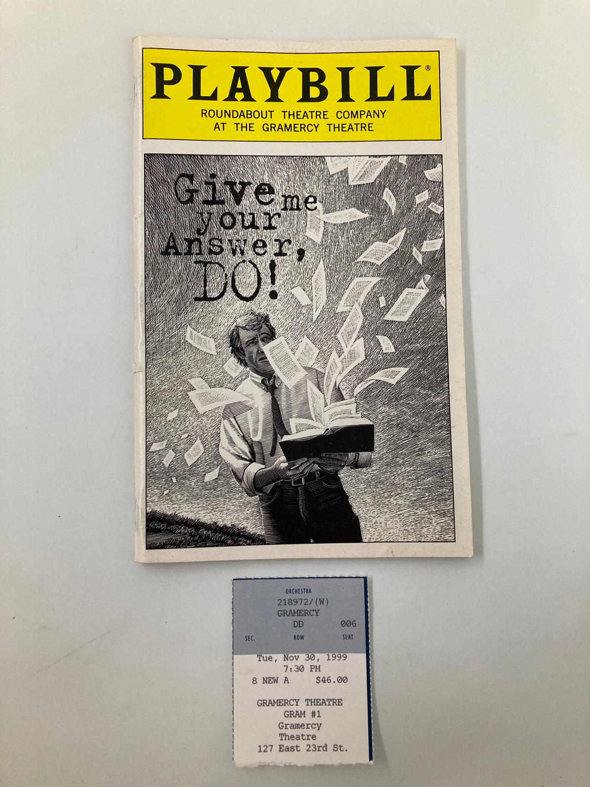 1999 Playbill for 'Give Me Your Answer, Do!' at the Gramercy Theatre featuring a graphic of a performer holding a box with flying dollar bills.