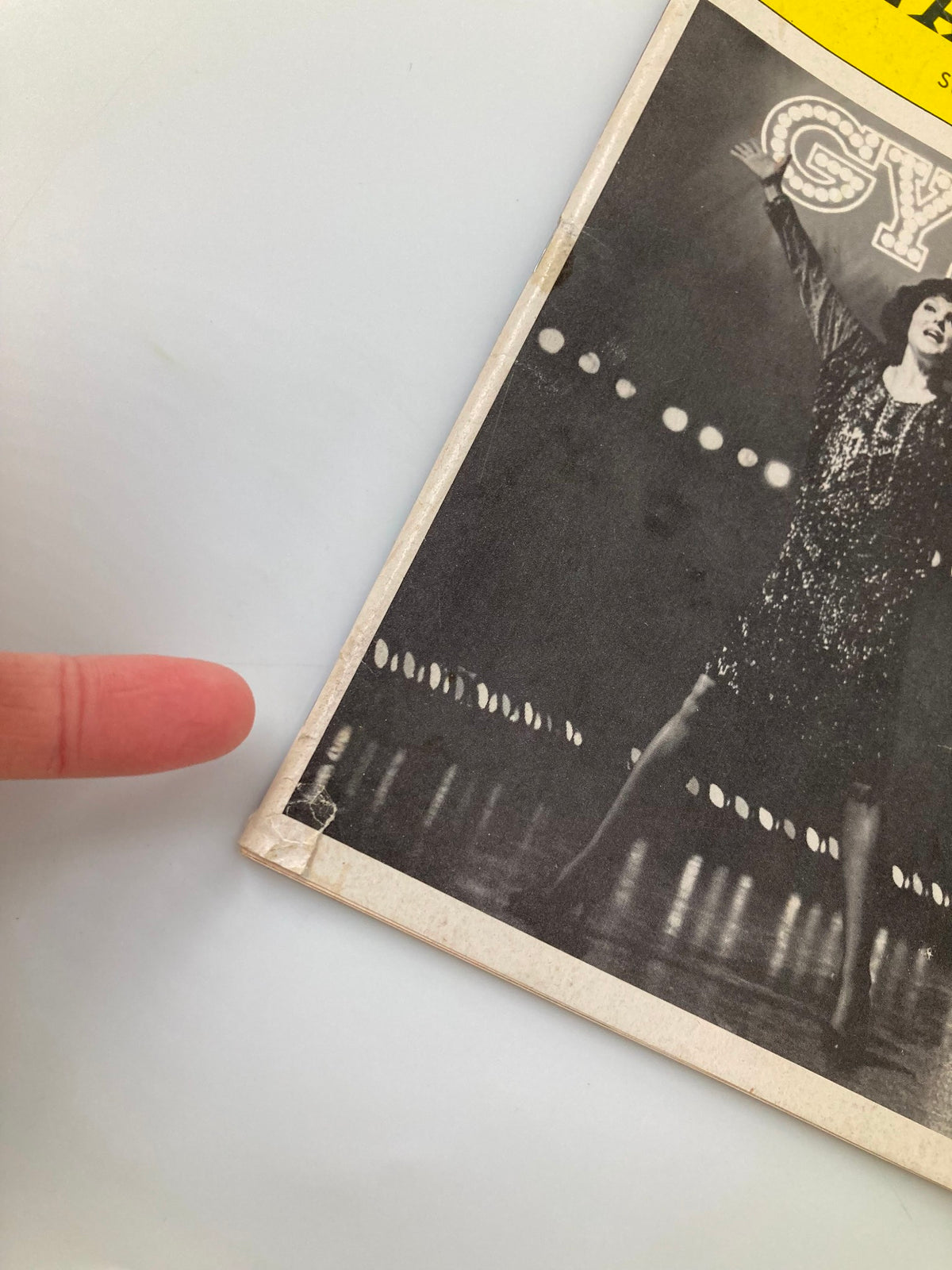 Close-up of the edge of the 1990 Playbill from St. James Theatre for Gypsy, showing minor wear and a small rip.