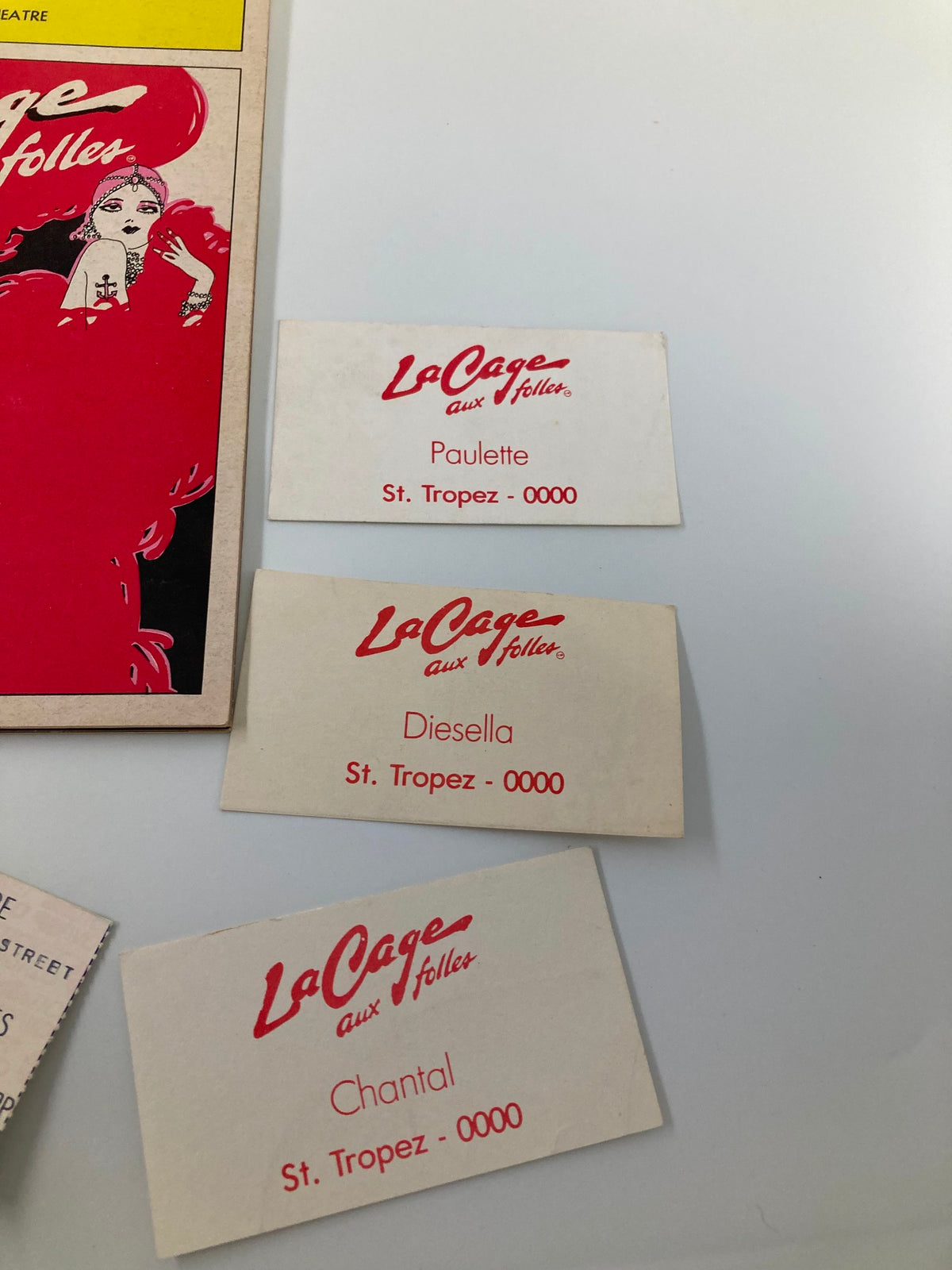Detailed shot of the Playbill 'La Cage Aux Folles' from The Palace Theatre with names of characters Paulette, Diesella, and Chantal alongside the iconic cover design.