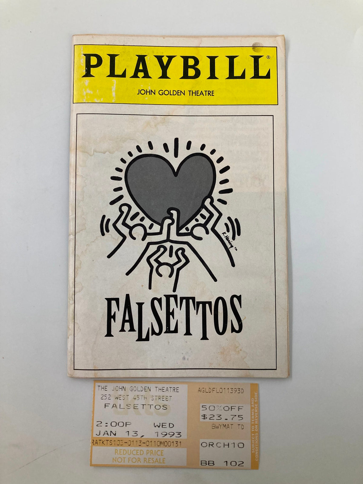 1993 Playbill for Falsettos at the John Golden Theatre featuring graphics of a heart and hands. Includes a ticket stub dated January 13, 1993, for a matinee performance.
