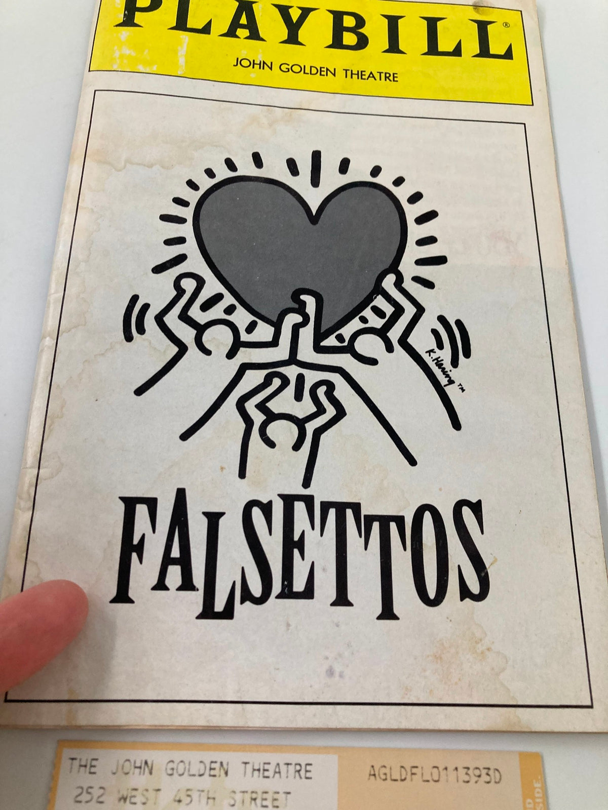 Close-up of the 1993 Playbill for Falsettos at the John Golden Theatre, highlighting the cover design and a ticket.