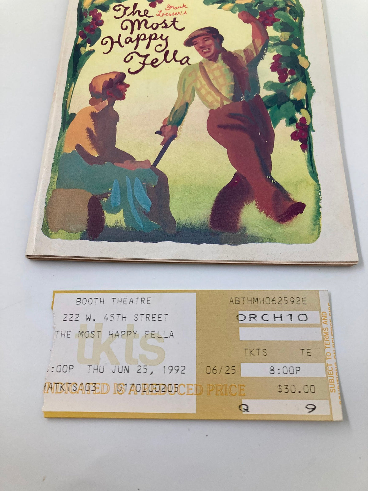 Detail of the original ticket for The Most Happy Fella, dated June 25, 1992, alongside the 1992 Playbill from The Booth Theatre.