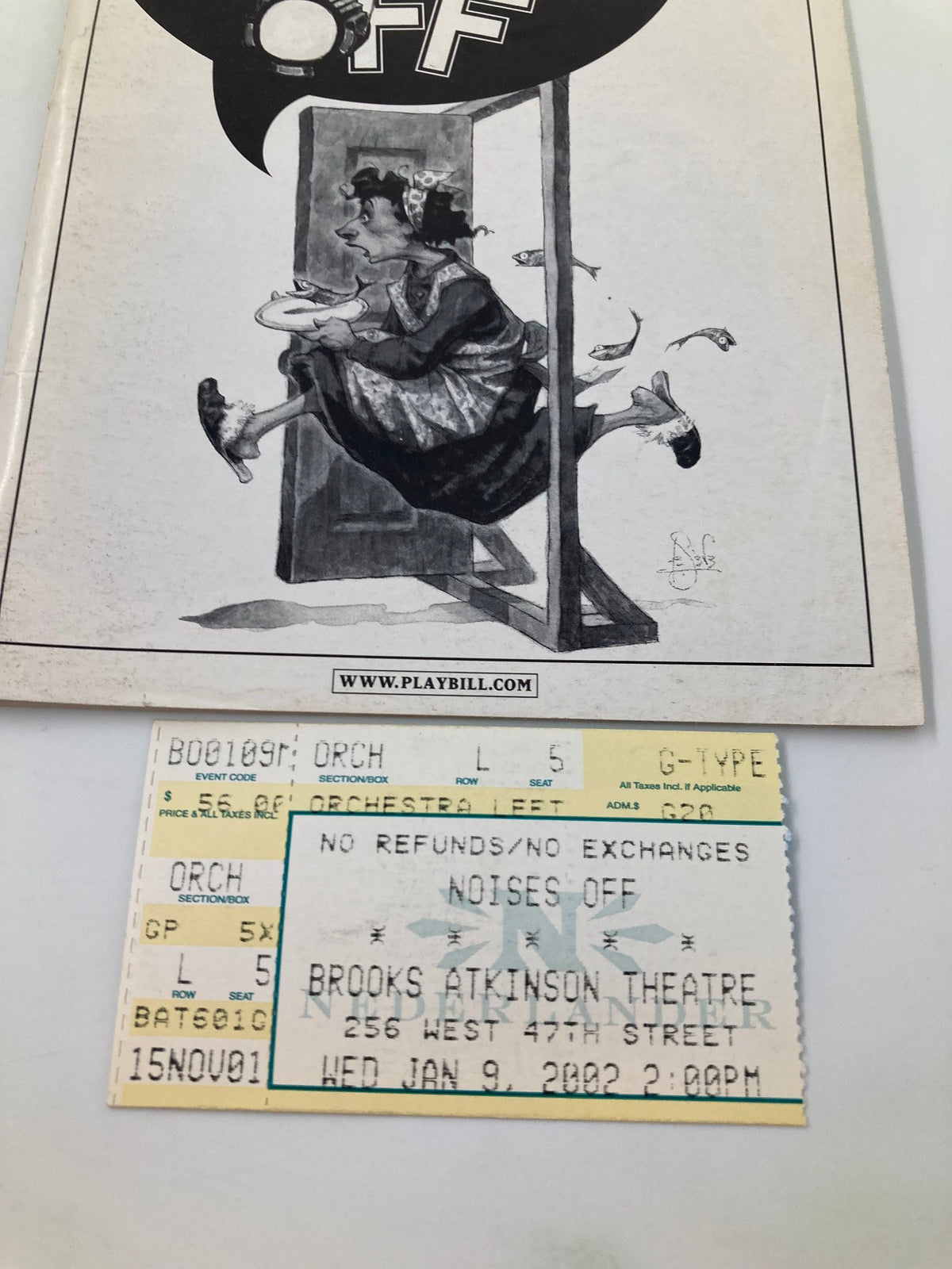 Close-up of the 2002 Playbill for Noises Off at Brooks Atkinson Theatre featuring ticket details and unique theatrical artwork.