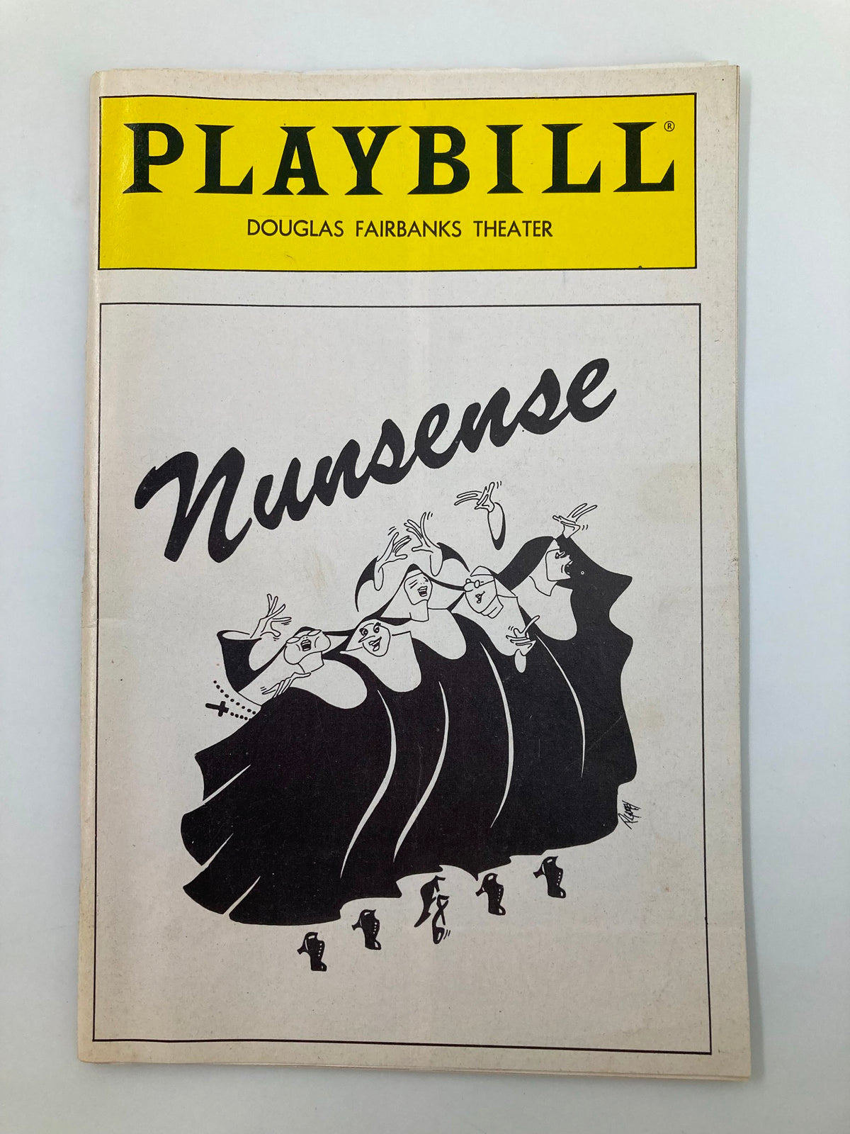 1991 Playbill for Nunsense featuring a cartoon illustration of nuns dancing, presented at the Douglas Fairbanks Theater.