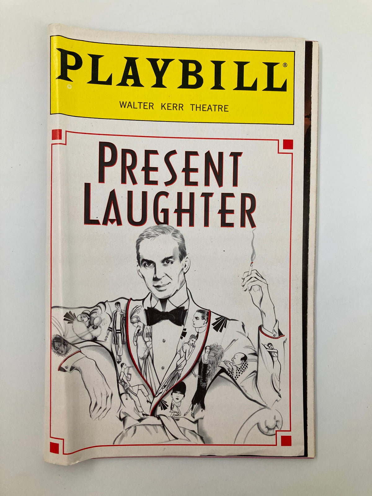 1996 Playbill for Present Laughter at Walter Kerr Theatre featuring a detailed illustration of a character in a tuxedo holding a cigarette, showcasing Broadway memorabilia.