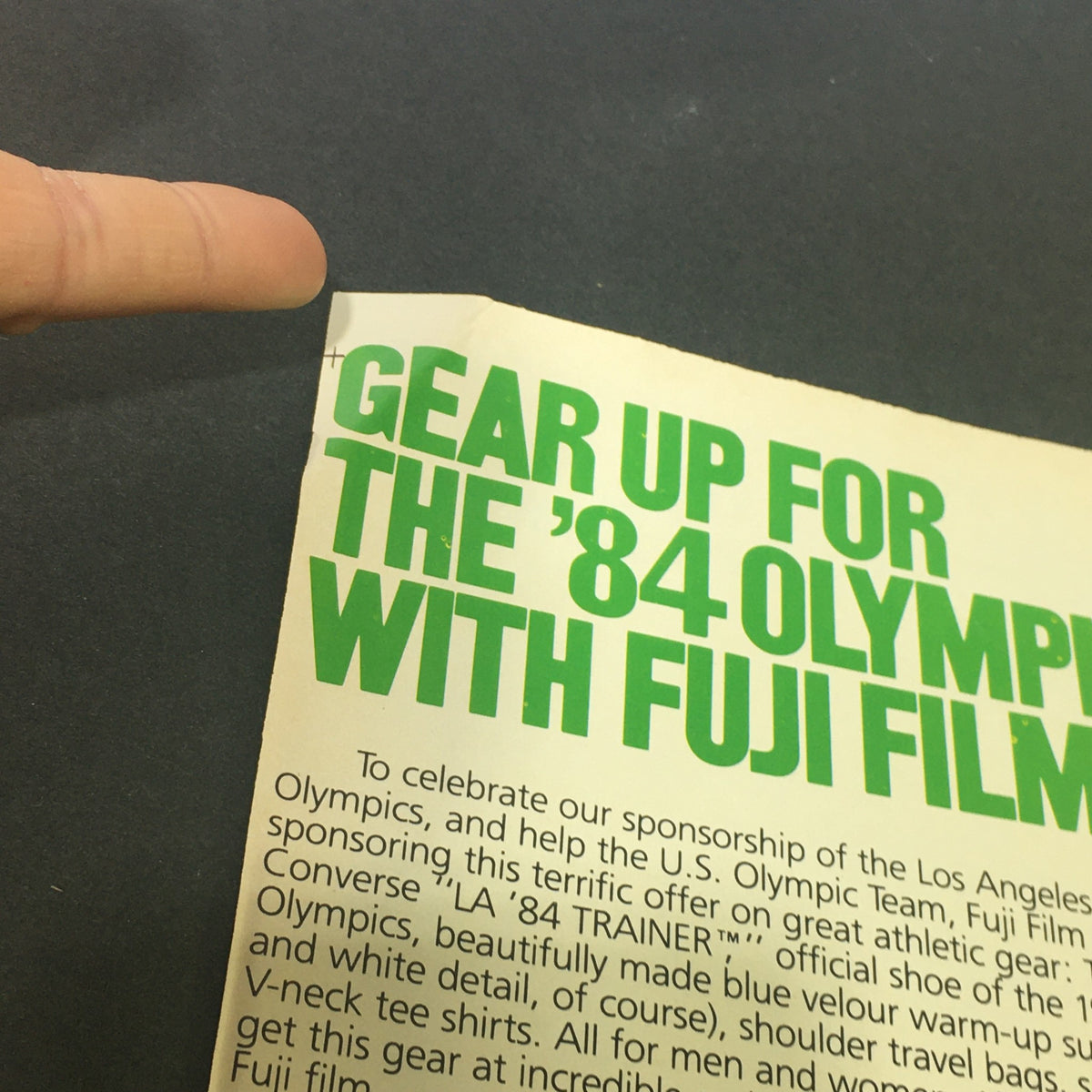 Close-up view of the vintage ad coupon from the VTG 1983 - Fuji Official Film of the Los Angeles 1984 Olympics Store Ad Coupon, showing promotional text to gear up for the 1984 Olympics with Fuji Film.