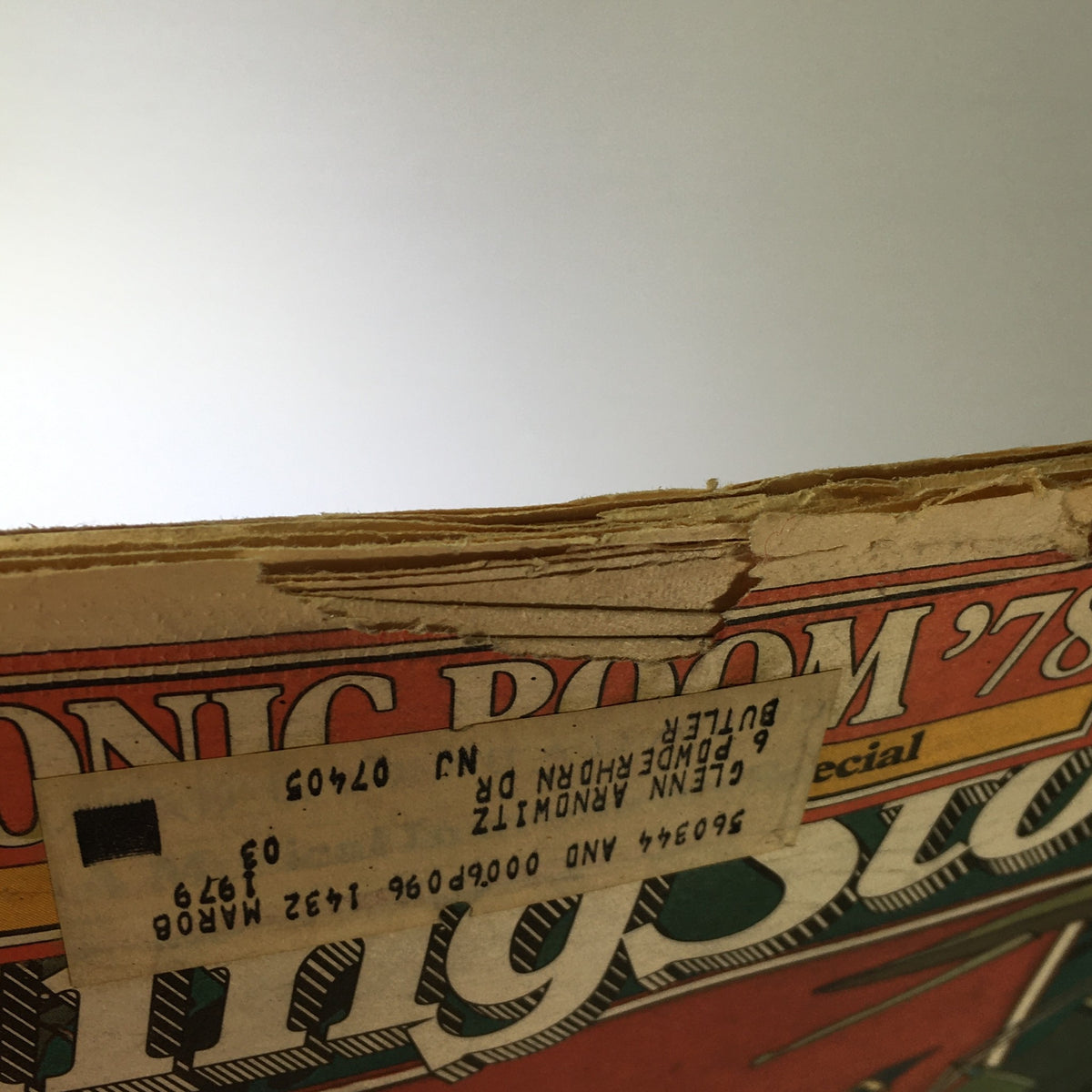 Close-up of the spine of a vintage Rolling Stone Magazine from February 9, 1978, with visible wear and a label, highlighting its age and collectible nature.