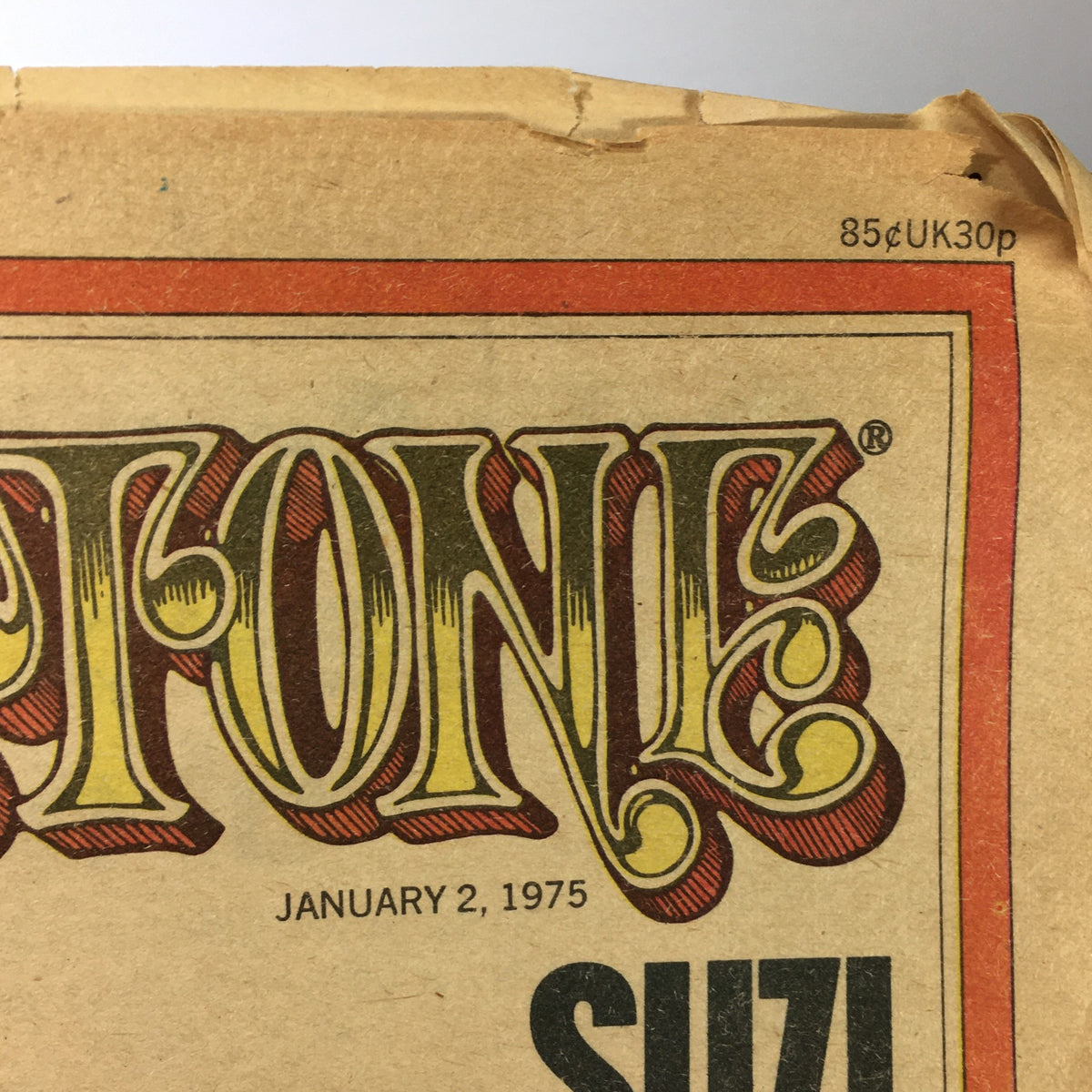 Top view of the cover of vintage Rolling Stone magazine January 2, 1975, featuring the date and title in bold artistic design, demonstrating its iconic style.