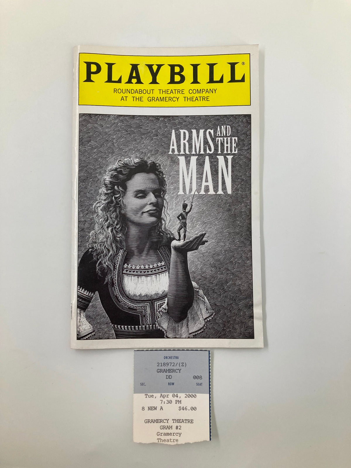 2000 Playbill for 'Arms and the Man' at the Gramercy Theatre featuring a vintage design with a woman holding a figurine and an original ticket from the April 4 performance.