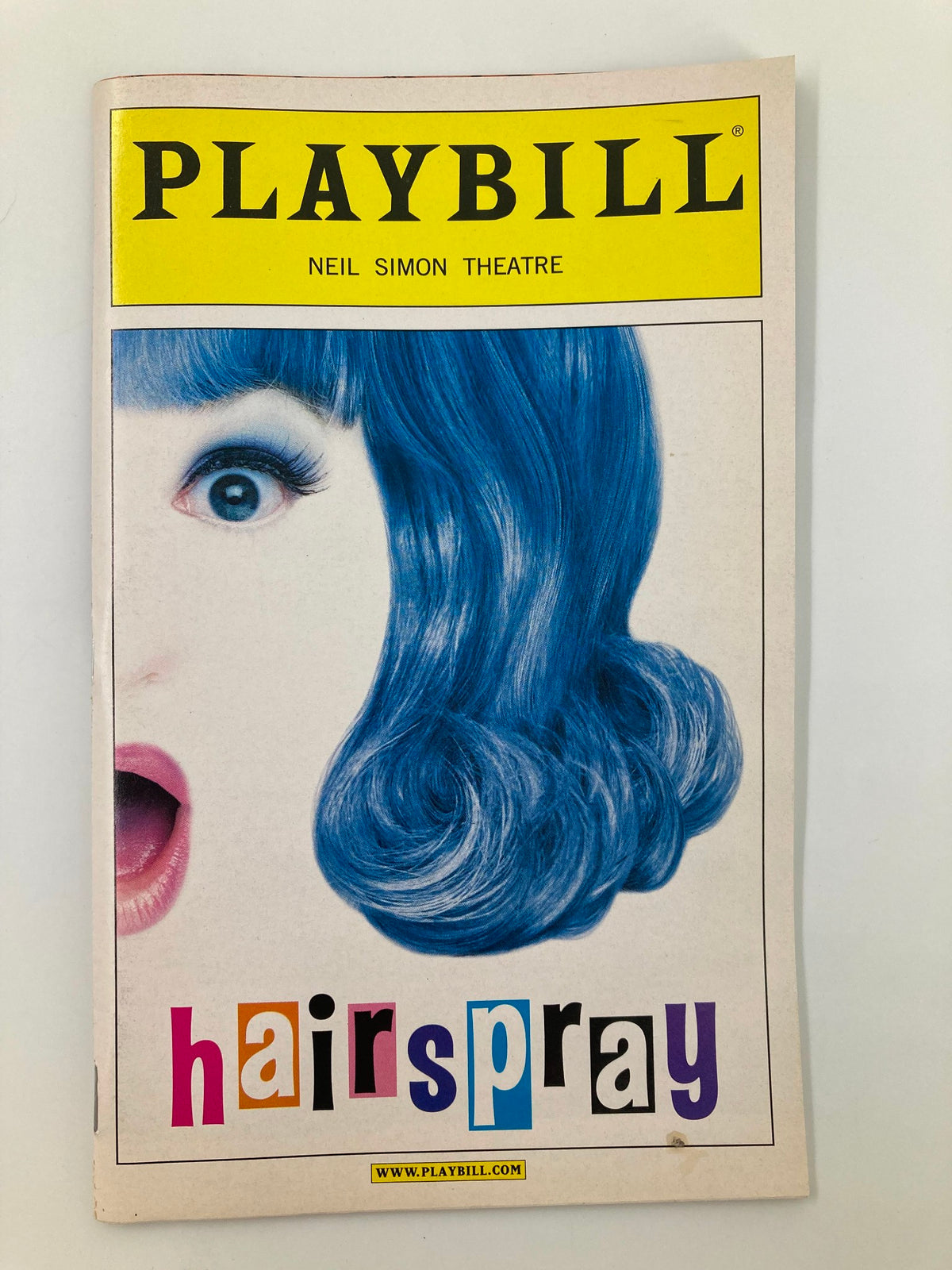 2002 Playbill from Hairspray showcasing vibrant cover art featuring a character with blue hair, Neil Simon Theatre.