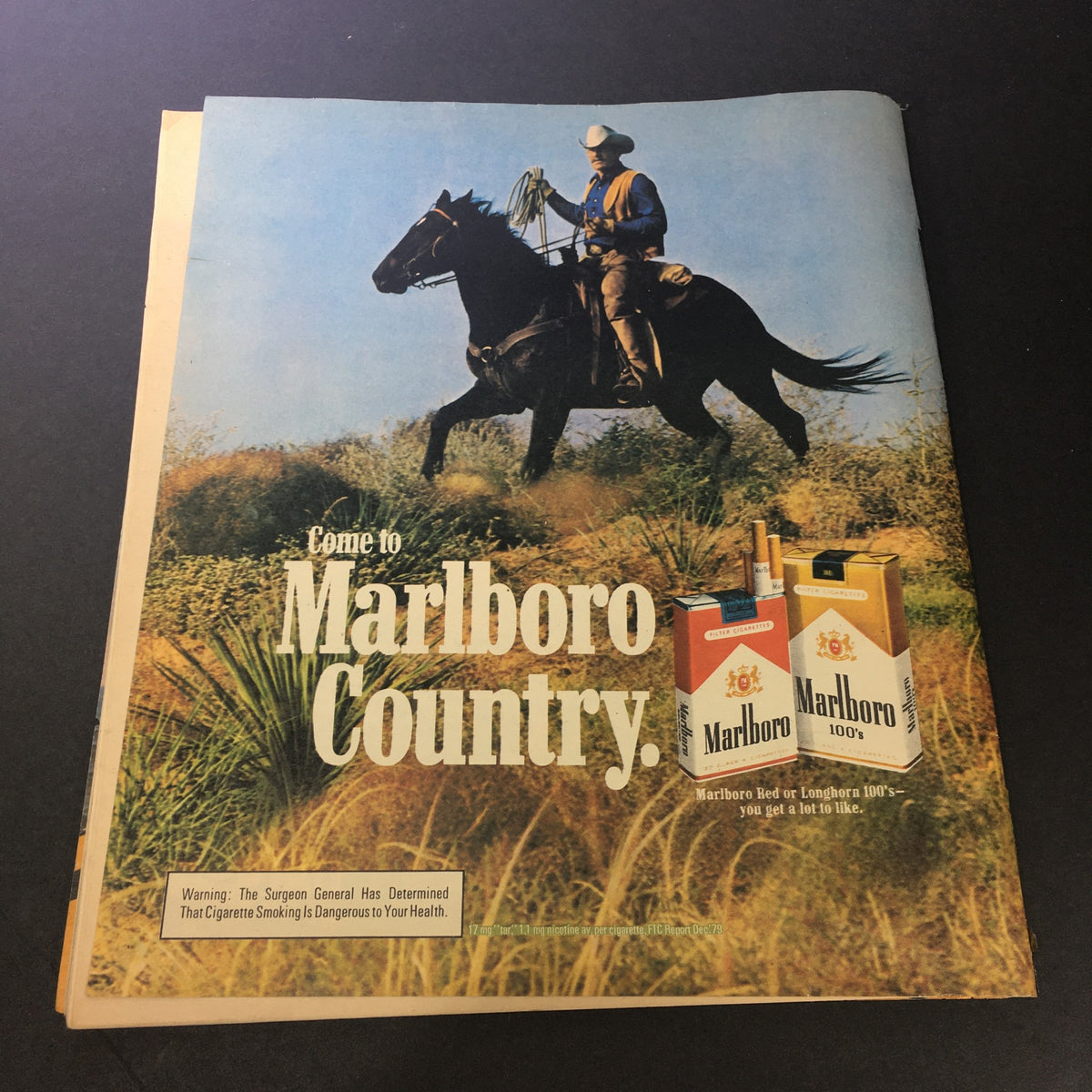 Vintage advertisement for Marlboro cigarettes featuring a cowboy on a horse in a natural landscape, with text that reads 'Come to Marlboro Country.' This nostalgic piece complements the VTG Rolling Stone Magazine June 11 1981 - James Taylor by Timothy White.