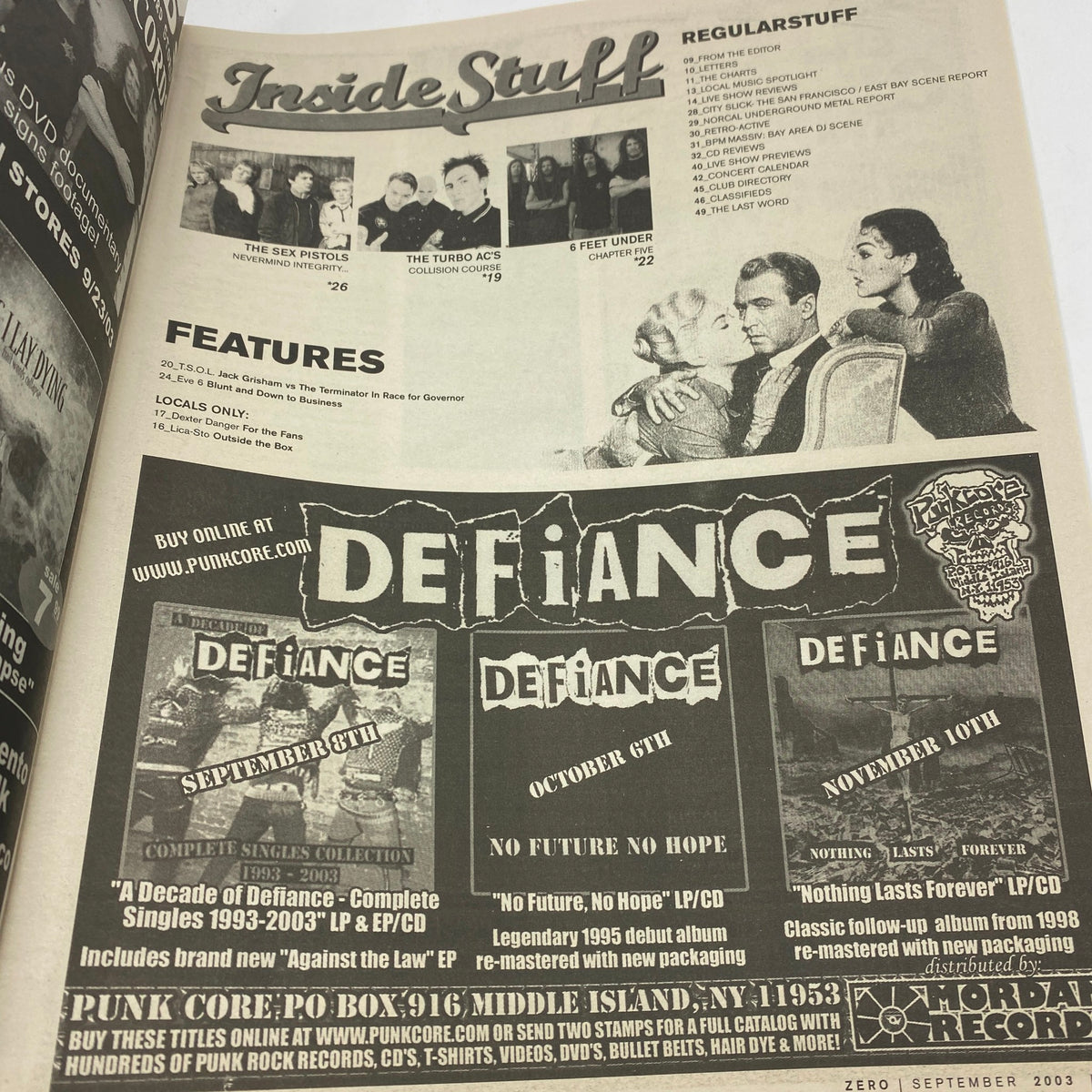 Inside page of Zero Magazine September 10 2003 displaying an advertisement for punk music compilations including 'Defiance' and various featured artists.