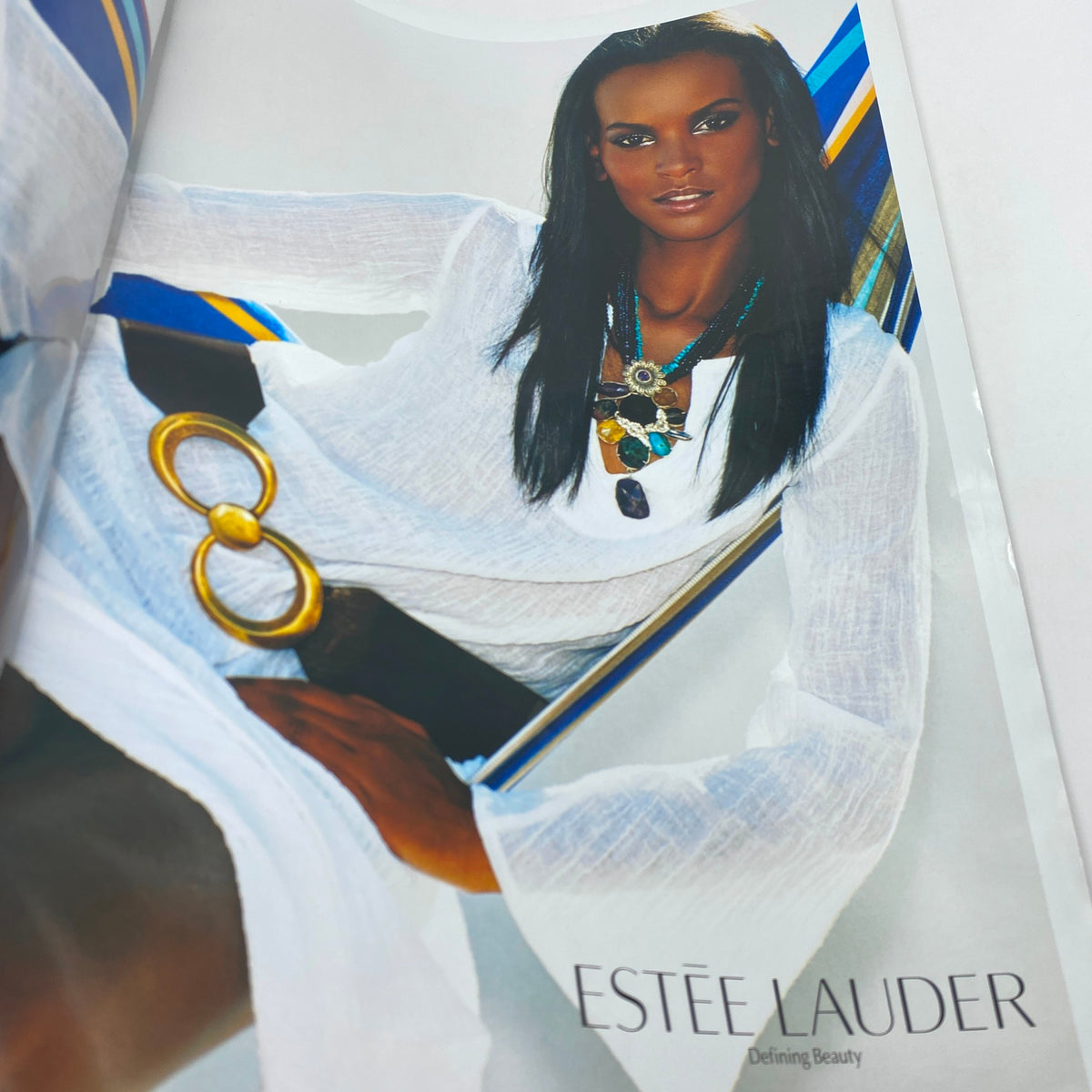V Magazine Summer 2005 No. 35 - Estee Lauder advertisement featuring a model in a white outfit with bold jewelry, emphasizing beauty trends from the summer of 2005.