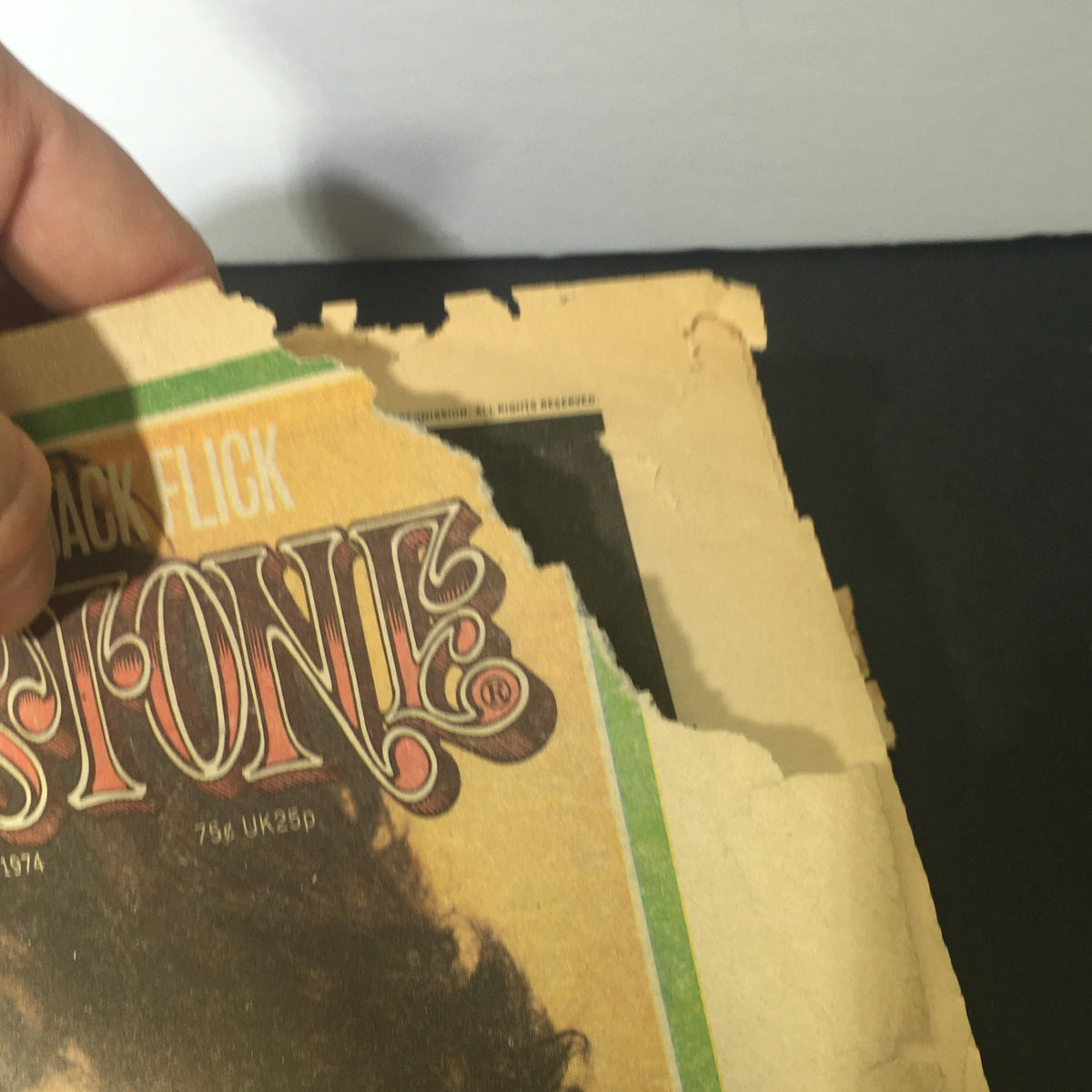 Showing the torn corner of the VTG Rolling Stone Magazine May 9, 1974 indicating its vintage and collectible nature.