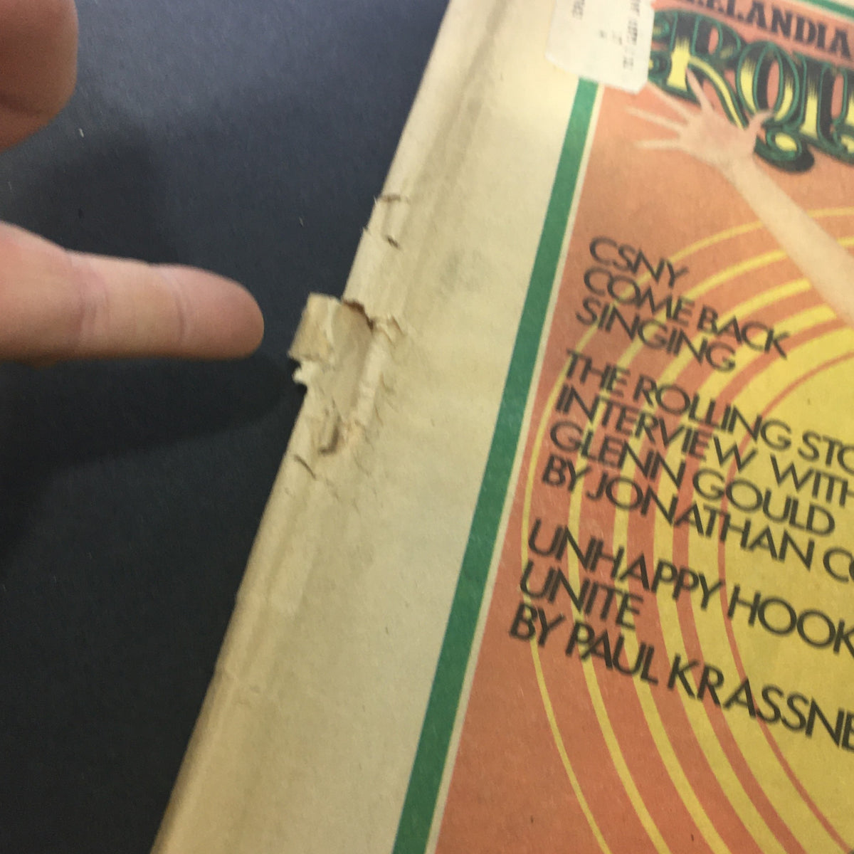 Close-up of the edge of the VTG Rolling Stone Magazine August 15 1974, highlighting the damage on the cover and the text detailing notable articles including 'CSNY Come Back Singing'.