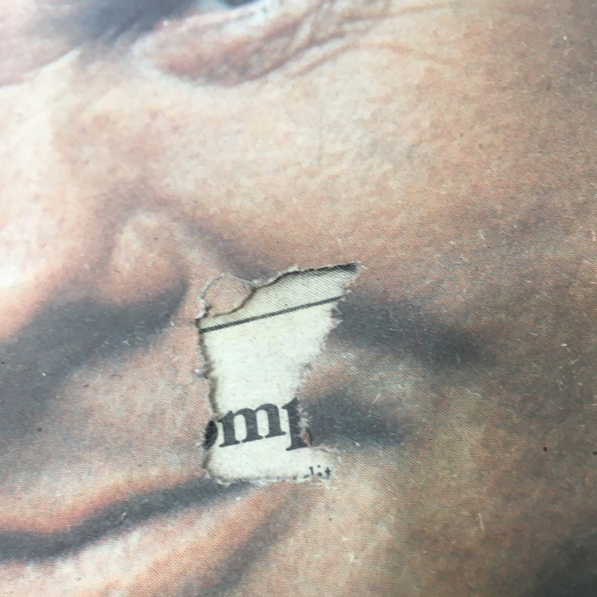 Close-up of a tear on the cover of the VTG Rolling Stone Magazine March 22 1979, revealing Johnny Carson's portrait and the magazine's historical significance.