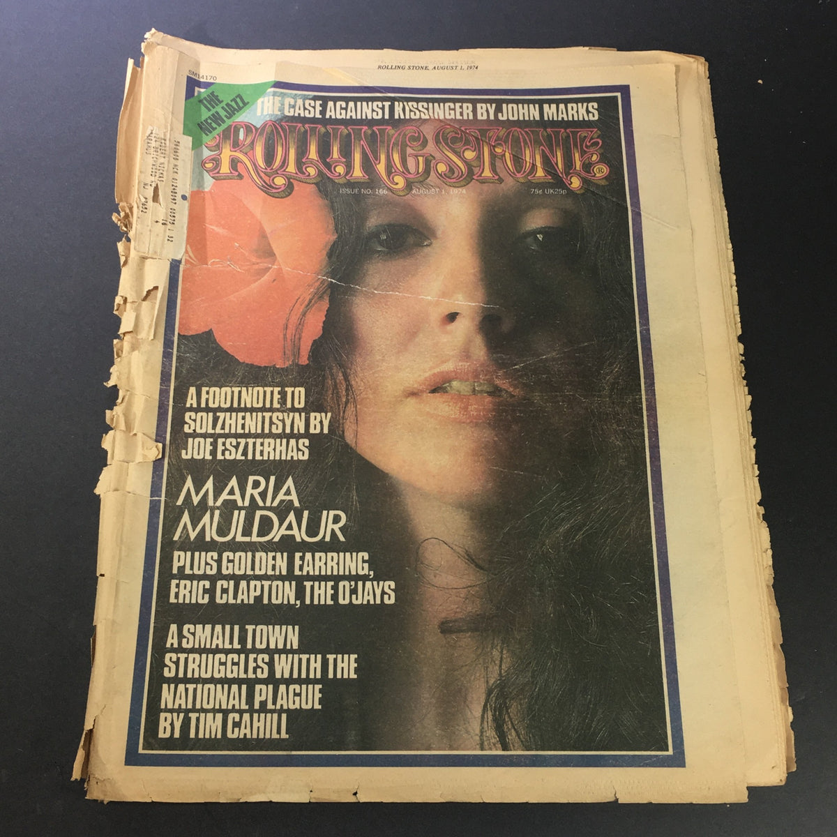 Vintage Rolling Stone Magazine from August 1, 1974 featuring Maria Muldaur and Eric Clapton on the cover, showcasing the artistic design and wear of the magazine.