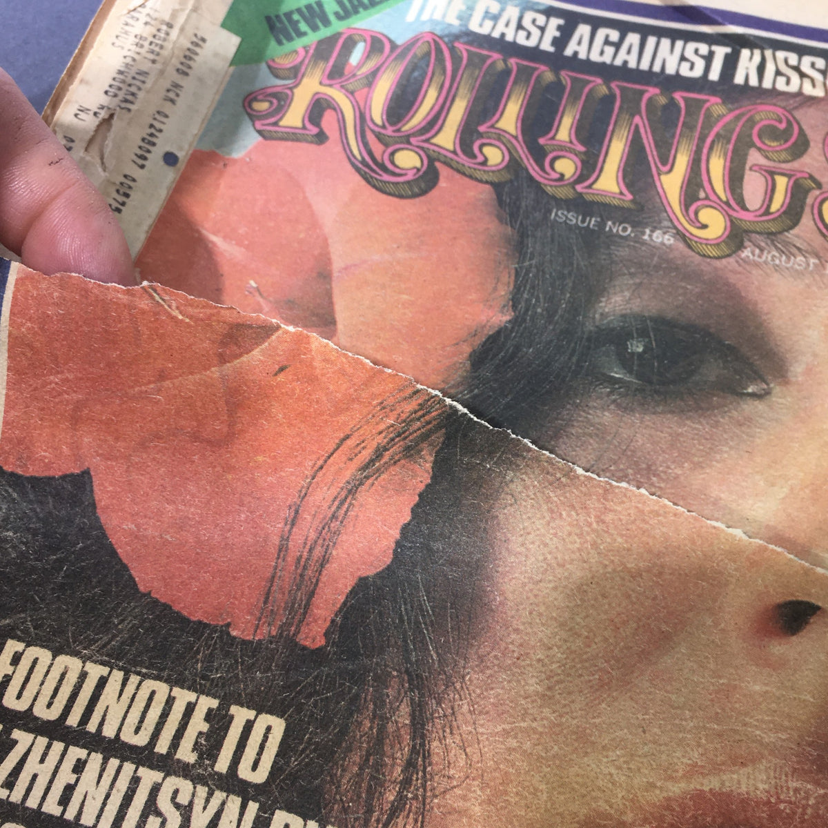 Detailed view of the edge of the Vintage Rolling Stone Magazine August 1, 1974, displaying significant wear and a close-up of the floral graphics near Maria Muldaur's image.