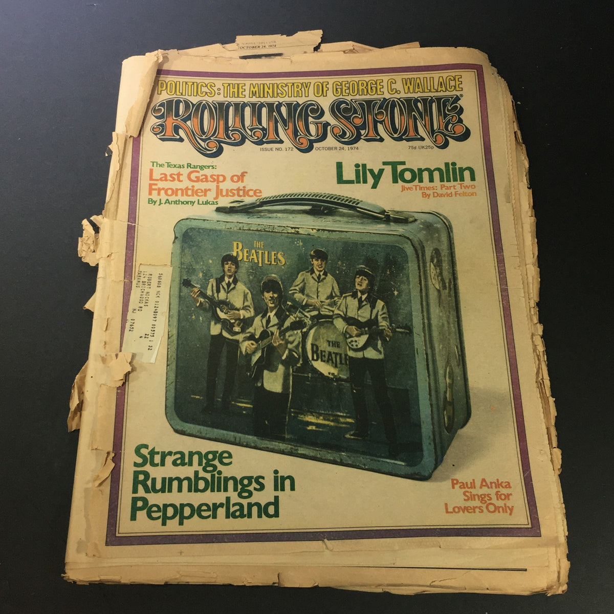 Vintage Rolling Stone Magazine cover from August 1, 1974 featuring a worn design with reference to The Beatles, alongside articles about prominent artists including Lily Tomlin and Paul Anka.