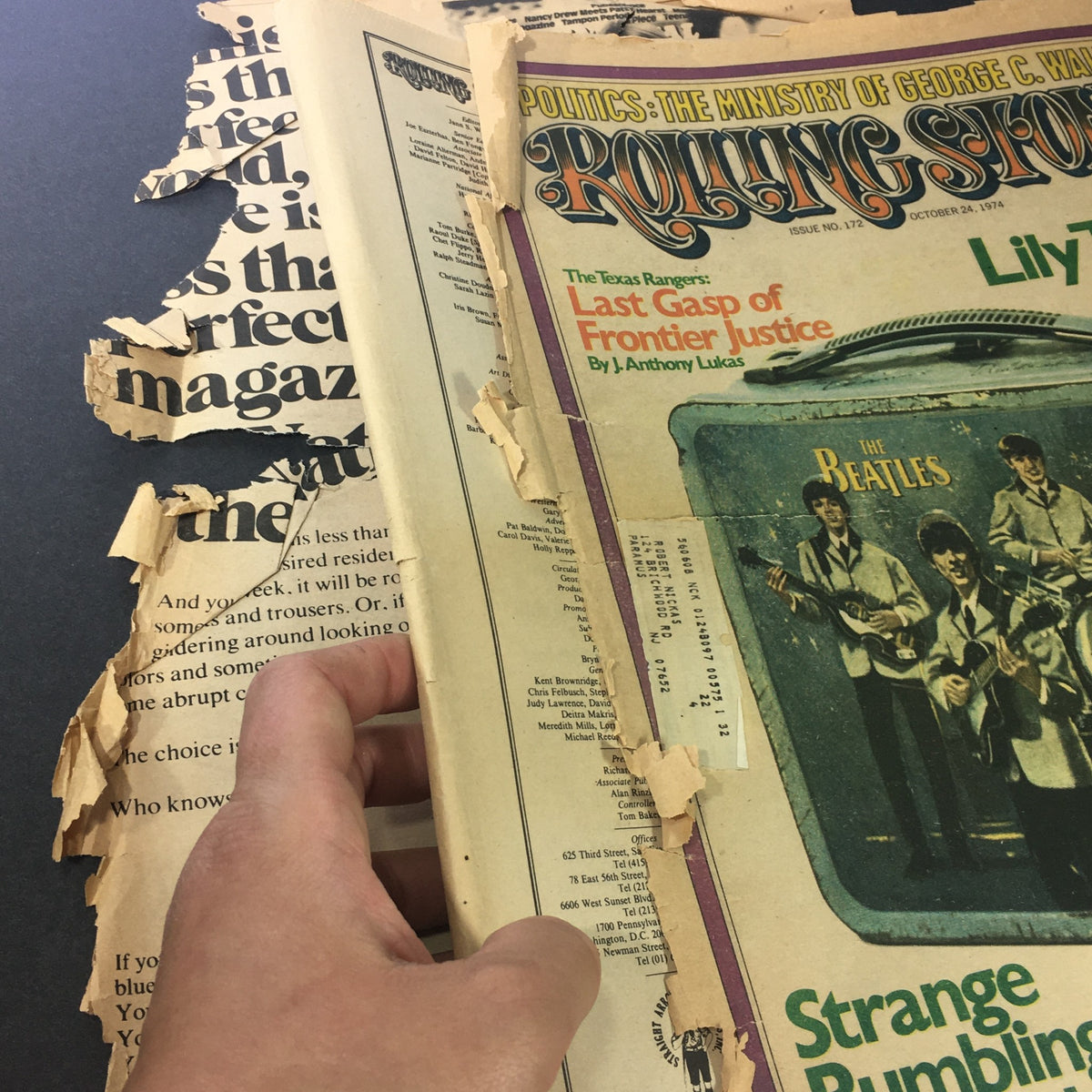 A close-up of the damaged pages of the Vintage Rolling Stone Magazine from August 1, 1974, revealing the torn edges and a glimpse of The Beatles imagery.