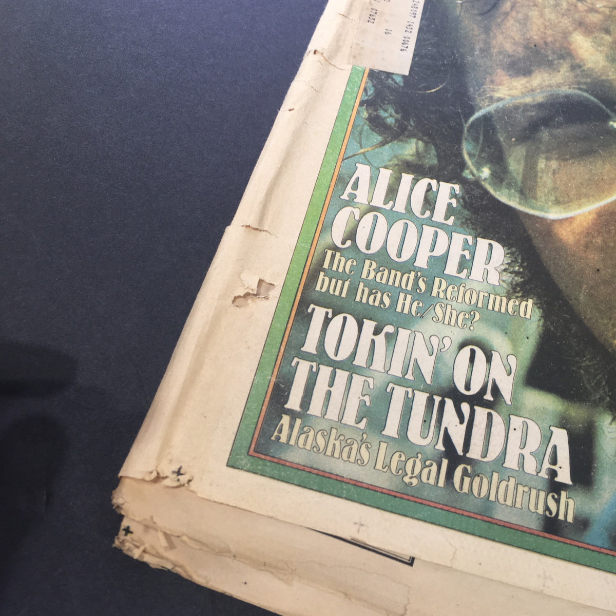 Close-up of the Vintage Rolling Stone magazine cover from July 31, 1975 highlighting Alice Cooper's name and article about him, indicative of the era's music scene.