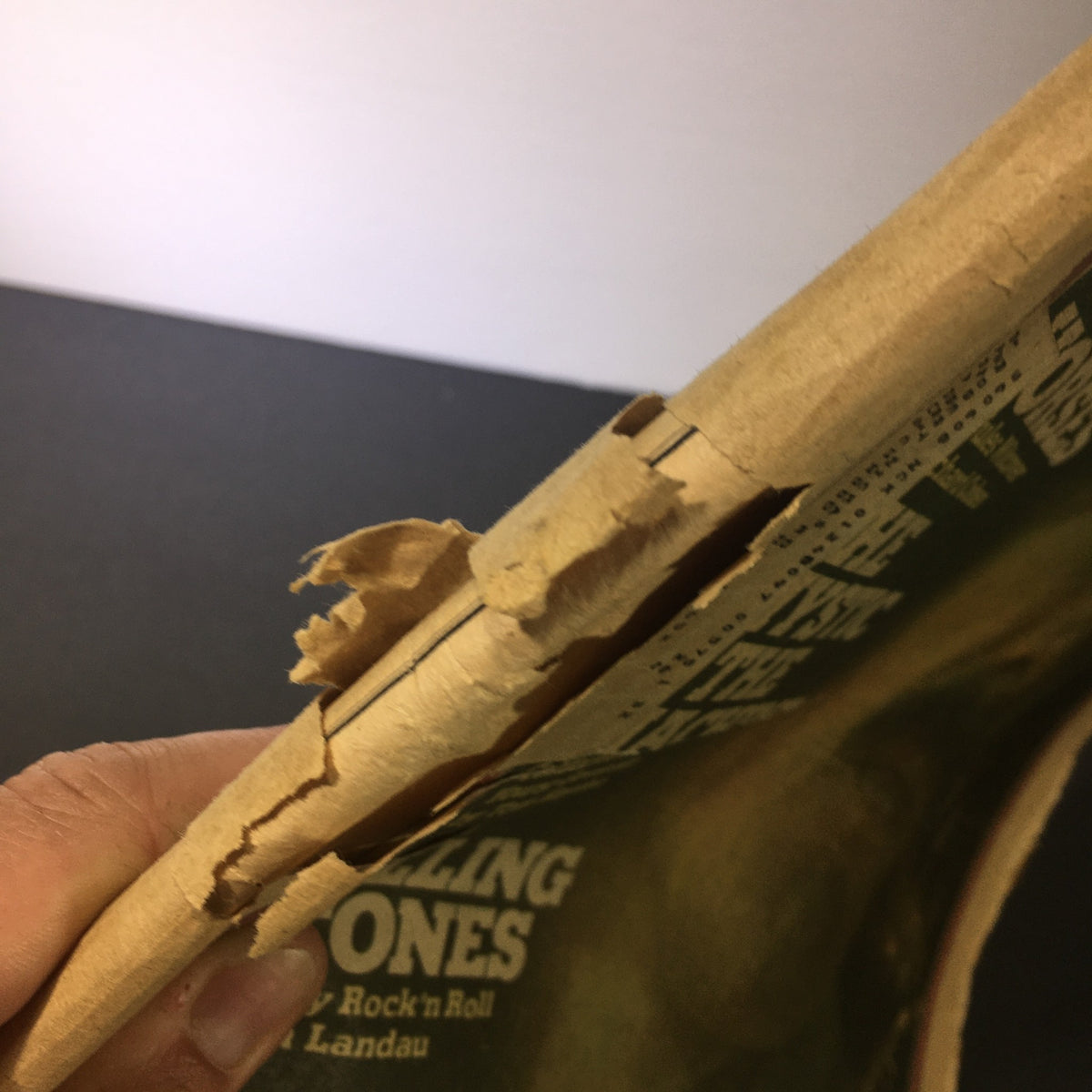 Side view of VTG Rolling Stone Magazine December 19 1974 showing damage to the spine and pages.