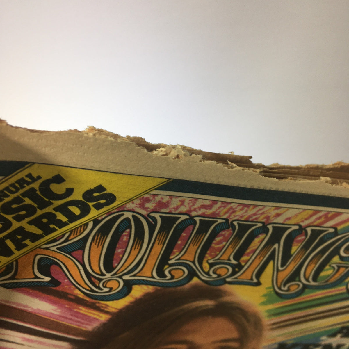 Side view of the top edge of Vintage Rolling Stone Magazine January 16 1975, demonstrating the wear and condition from collection and preservation efforts.