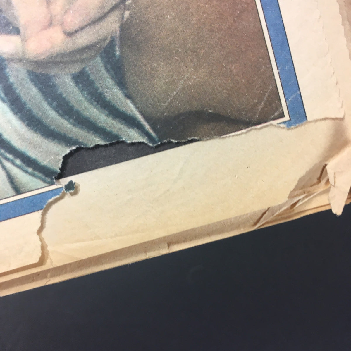 Damaged edge of vintage Rolling Stone Magazine from May 22, 1975 with Carly Simon on the cover, illustrating its condition and vintage appeal.